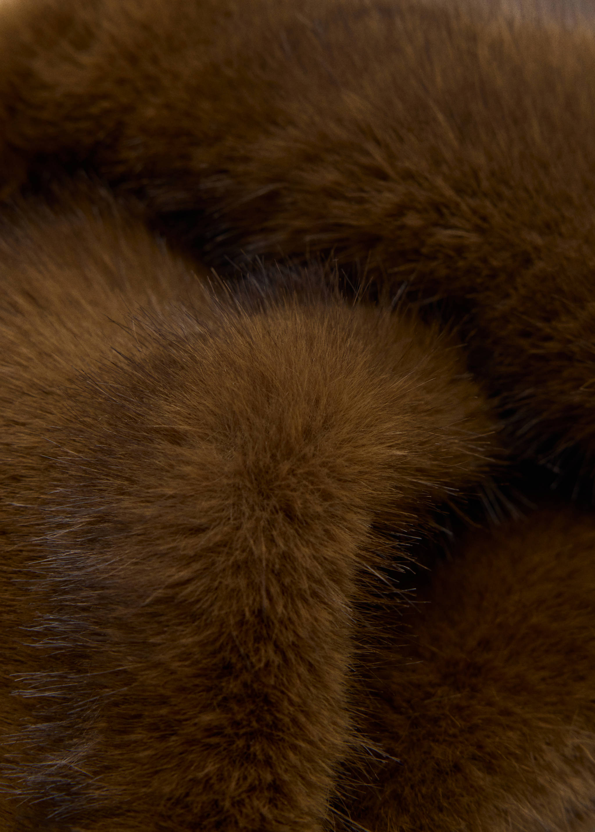 Brown faux-fur scarf close-up.