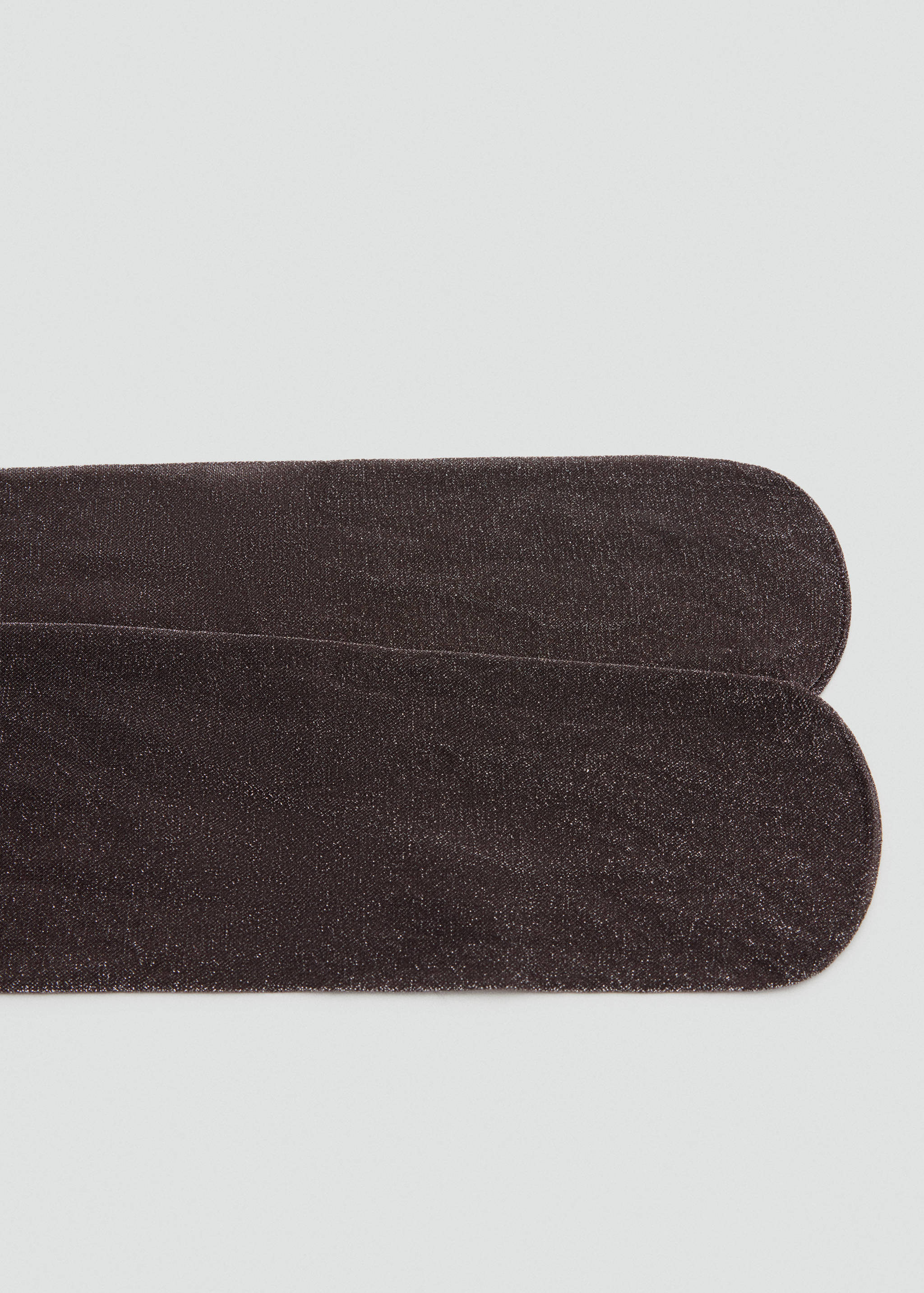 Close-up of shimmering dark brown tights toe section.