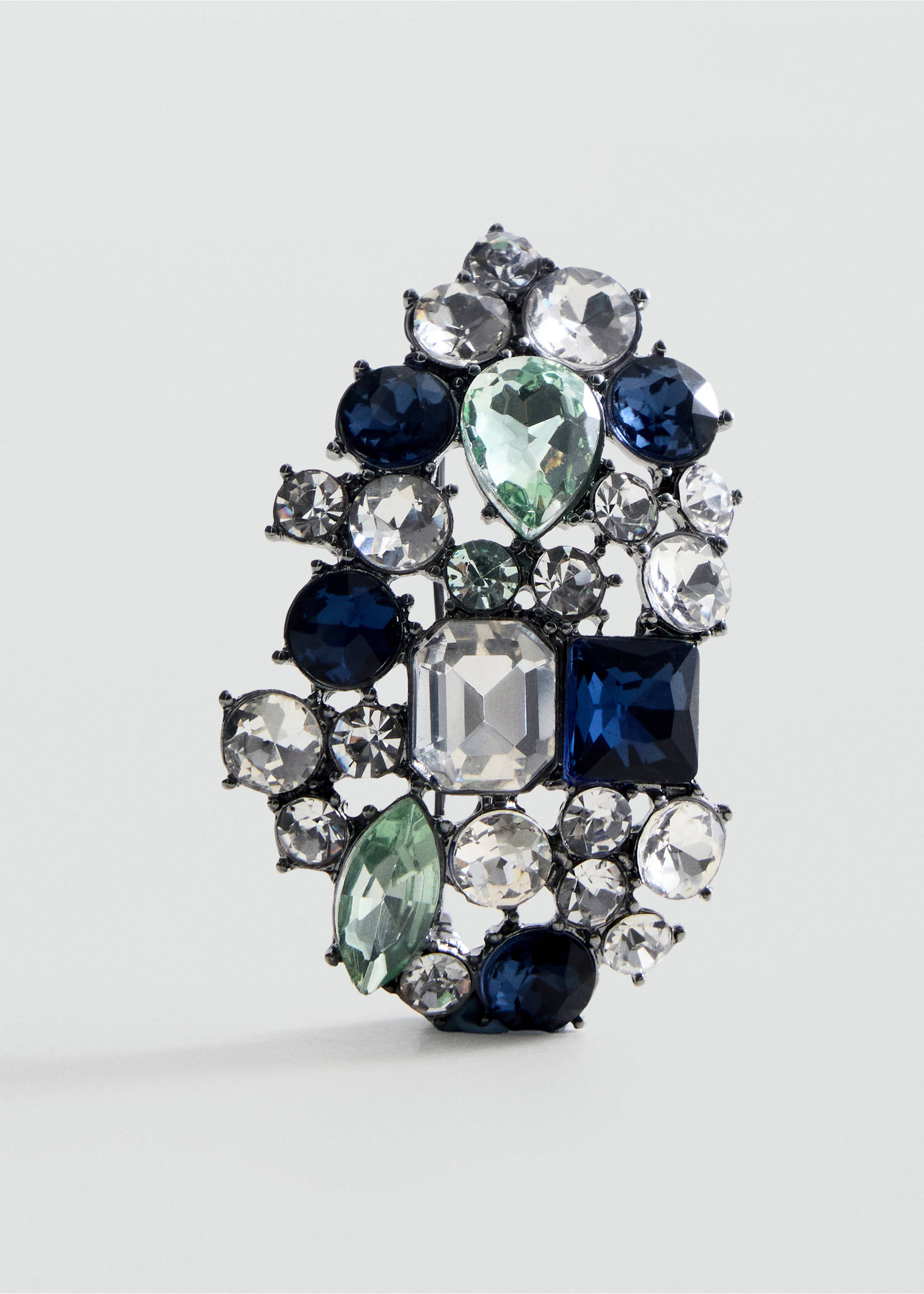 Close-up of a rhinestone brooch in clear, navy and mint green stones., Silver. Ref: 47081386-00.