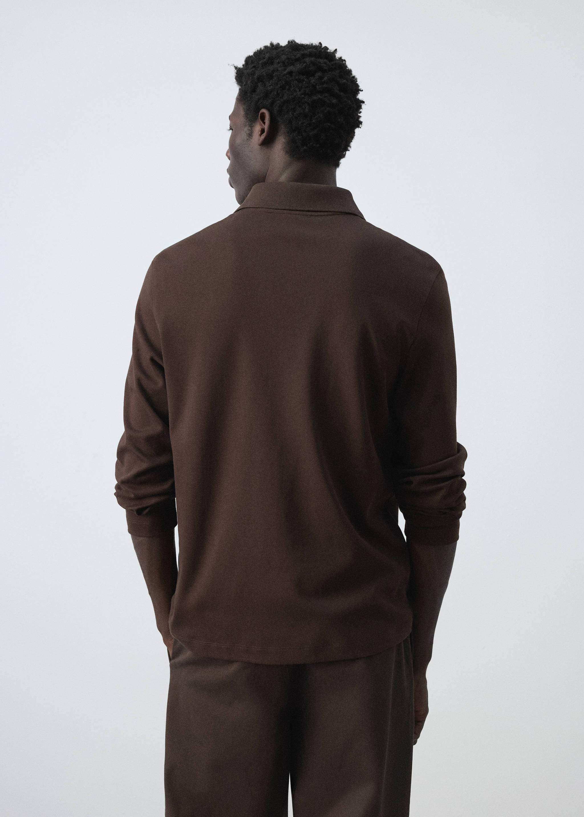 Back view of a brown long-sleeved polo shirt with a collar.