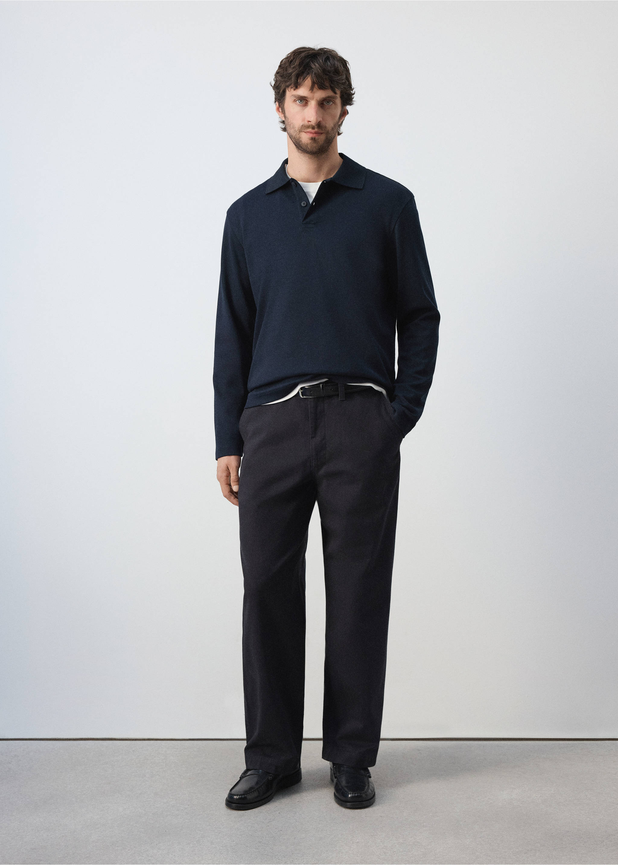 Navy blue long-sleeved knit polo shirt worn with dark trousers., Navy. Ref: 47081410-00.