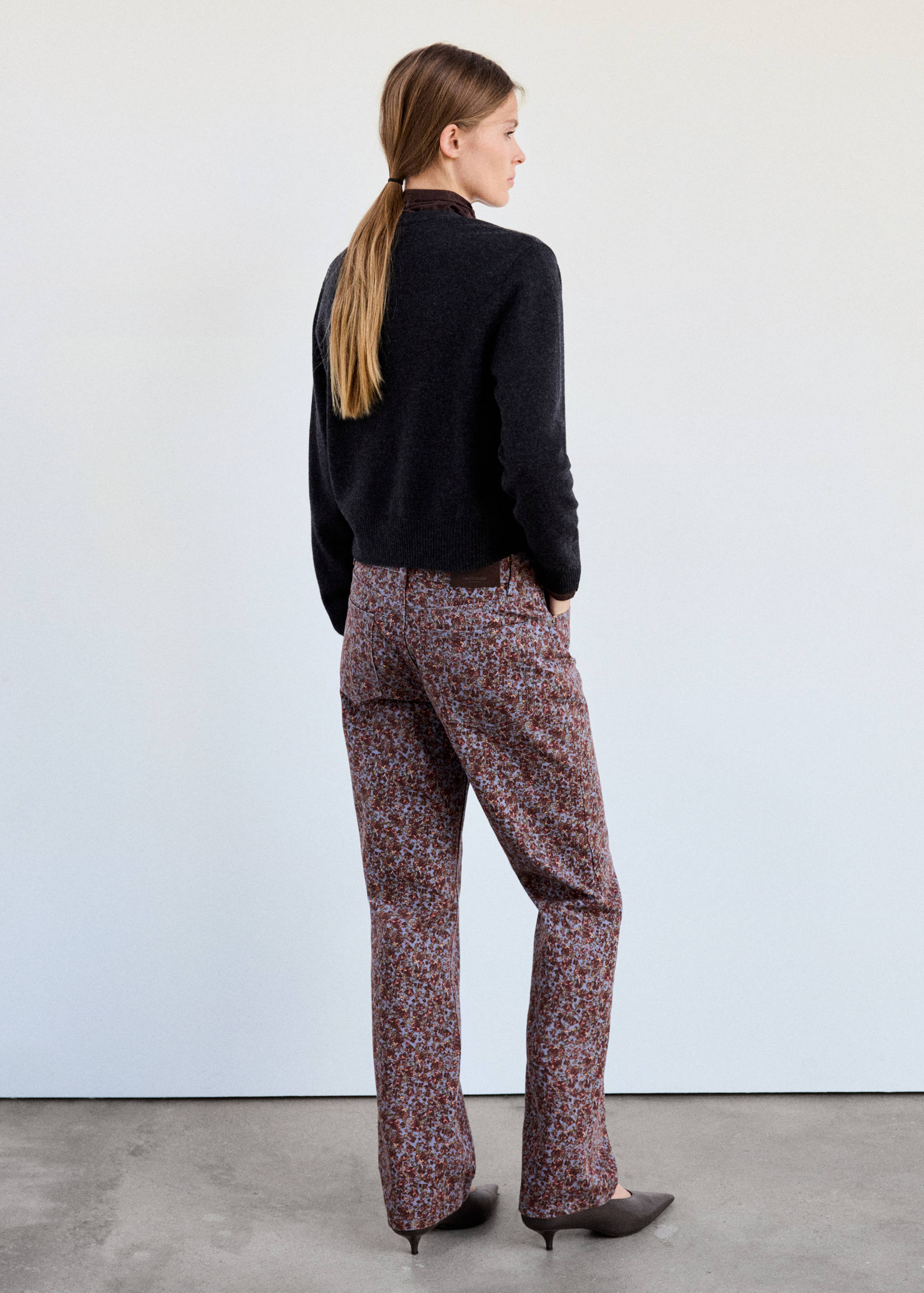 Back view of printed floral straight trousers in blue and brown.