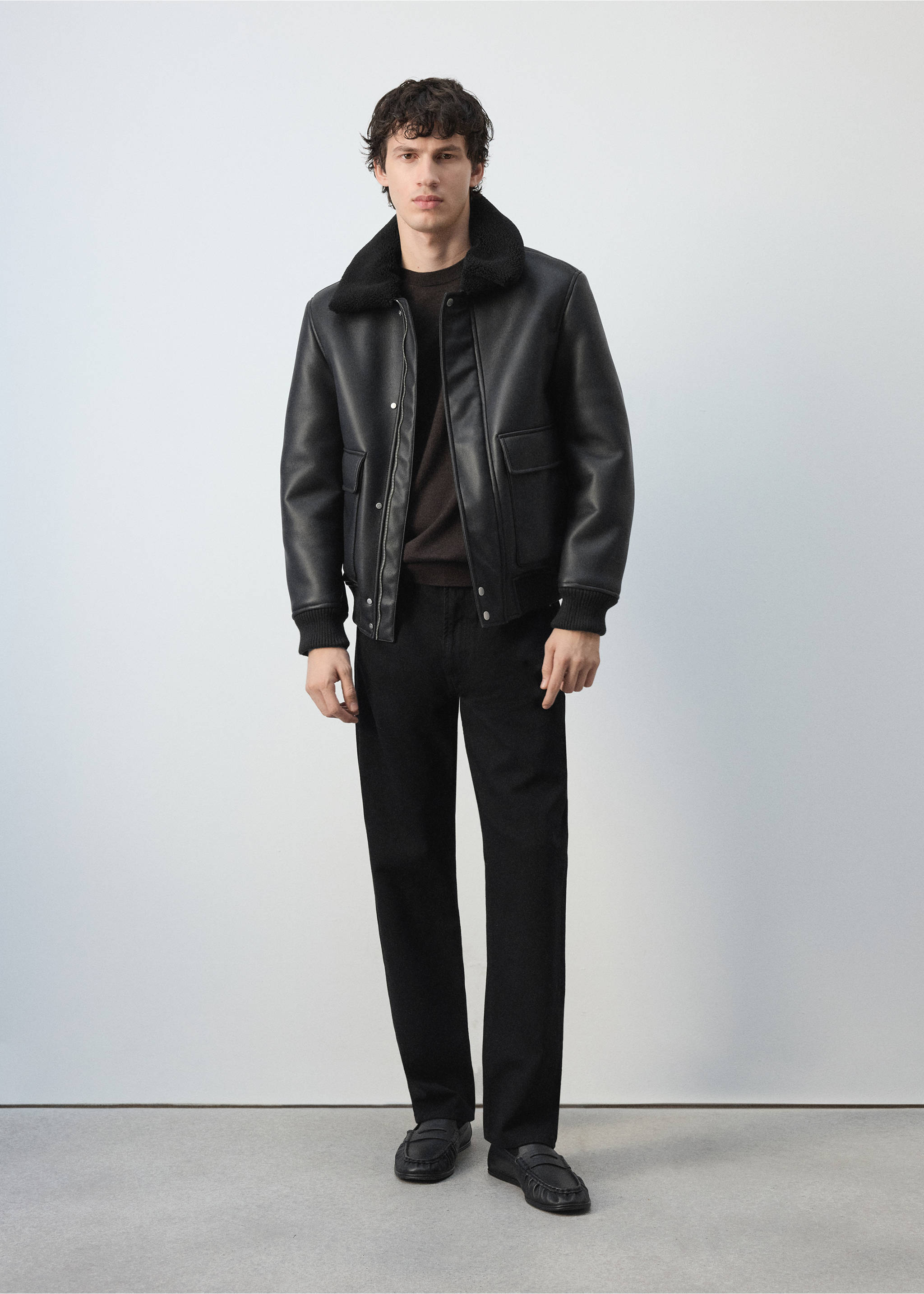 Black faux-leather jacket with a faux-fur collar, worn with dark trousers., Black. Ref: 47091329-00.