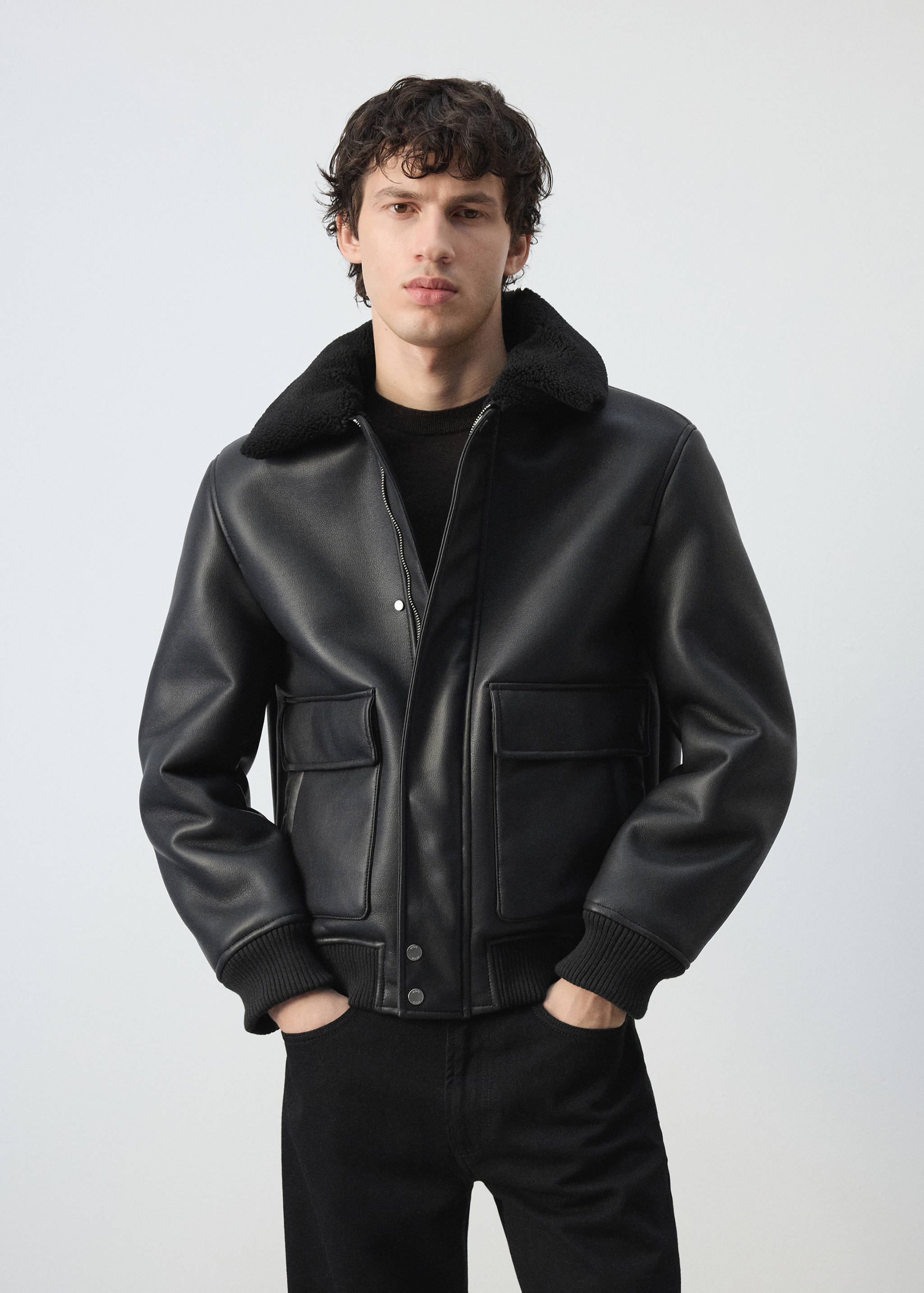 Black faux-leather bomber jacket with faux-shearling collar and flap pockets.