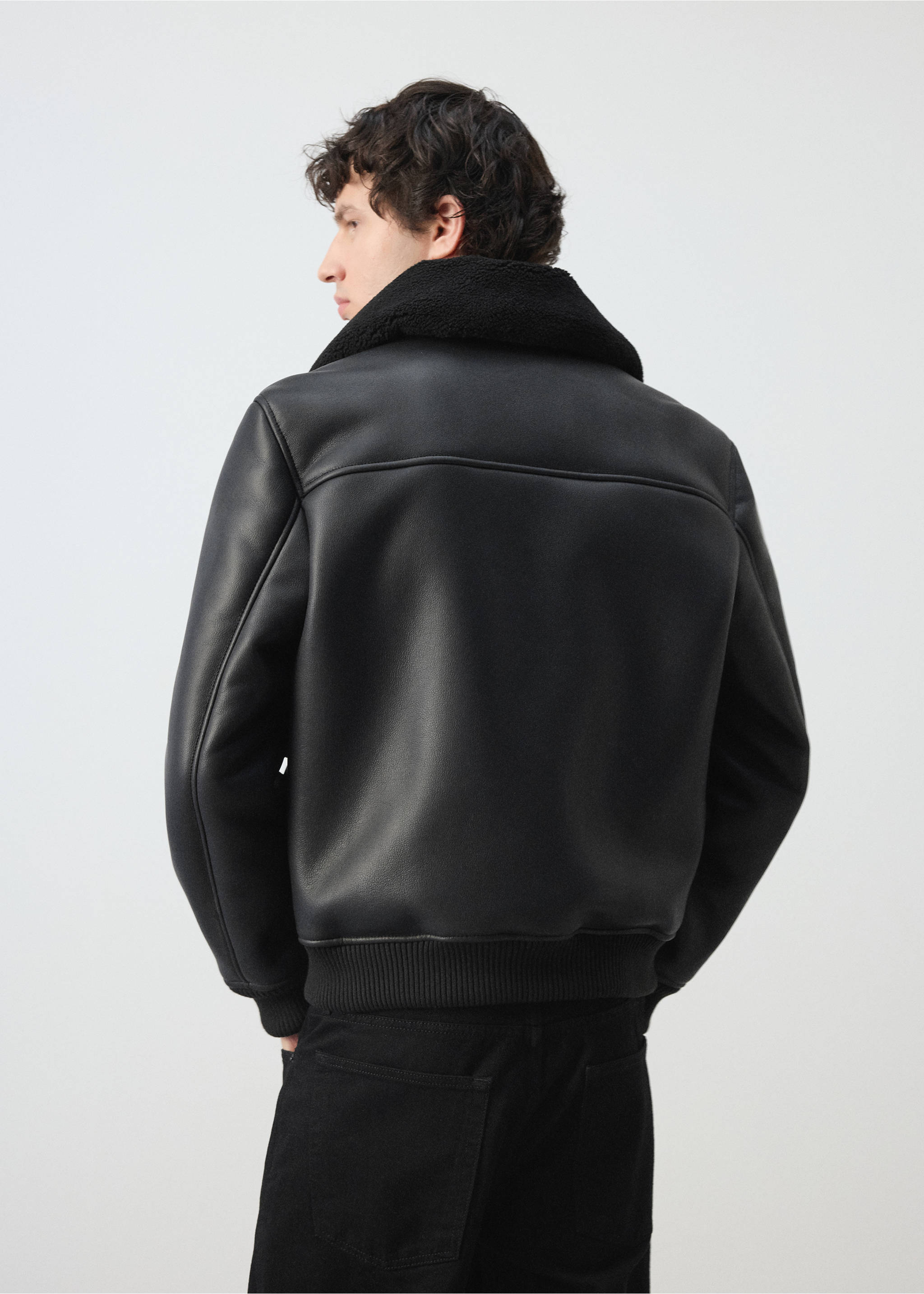 Back view of a black jacket with a faux-shearling collar and ribbed hem., Black. Ref: 47091329-00.