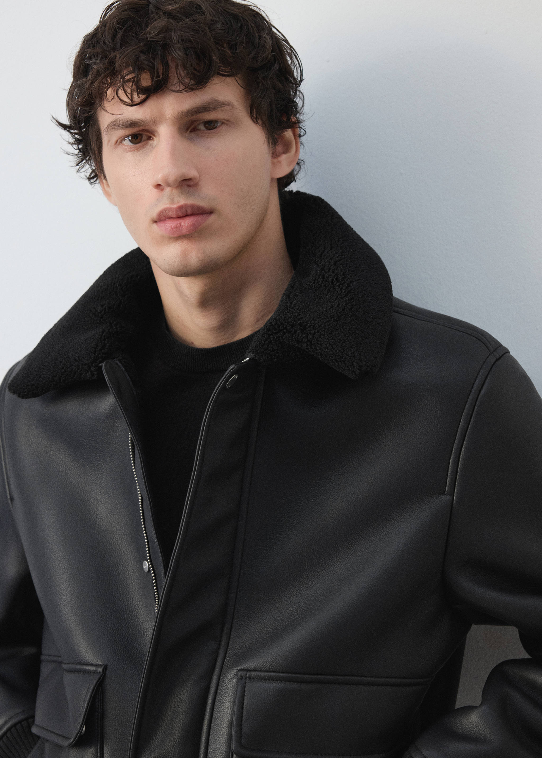 Black jacket with a black faux-shearling collar.