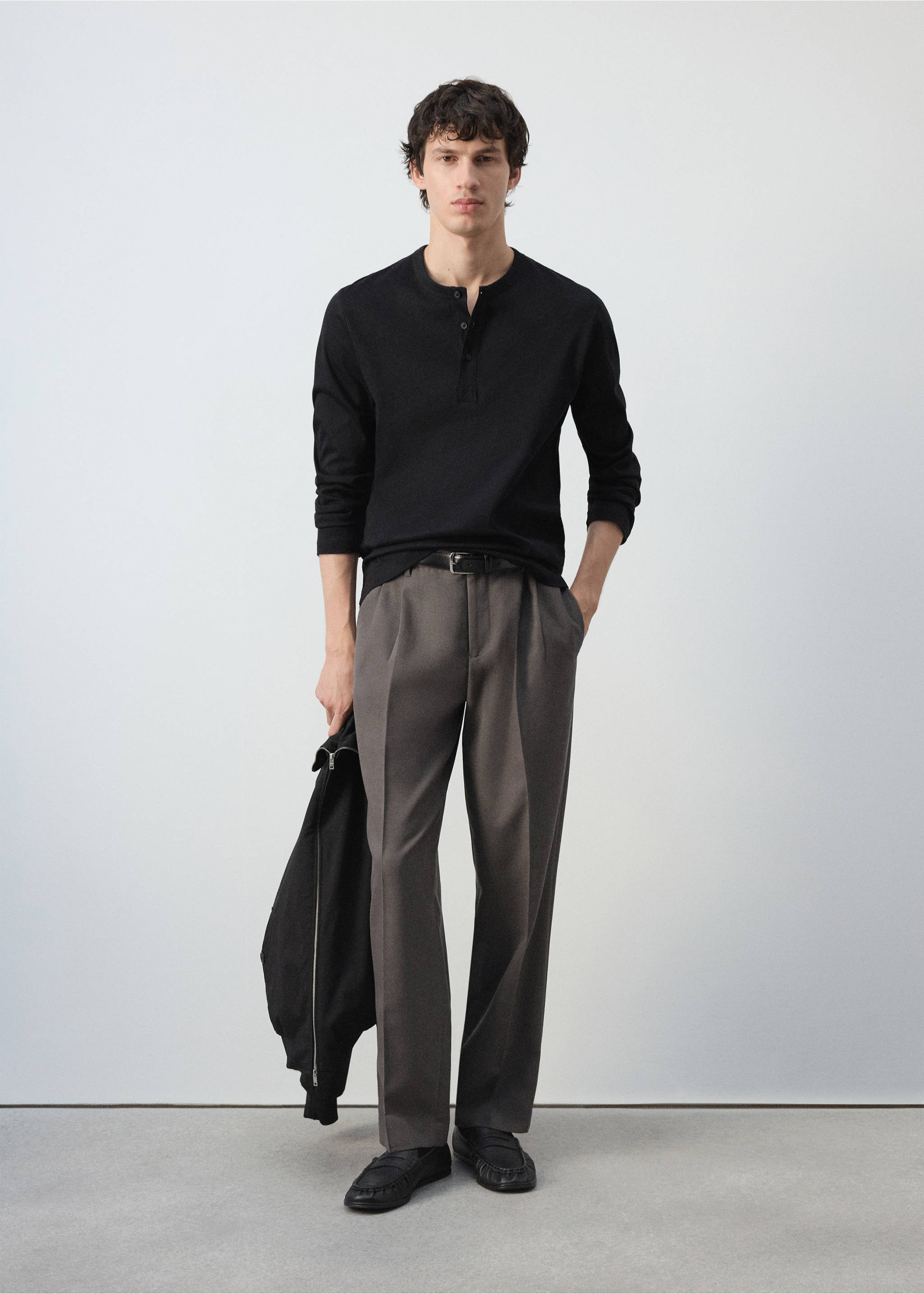 Black long-sleeved henley t-shirt worn with grey trousers., Black. Ref: 47091350-00.