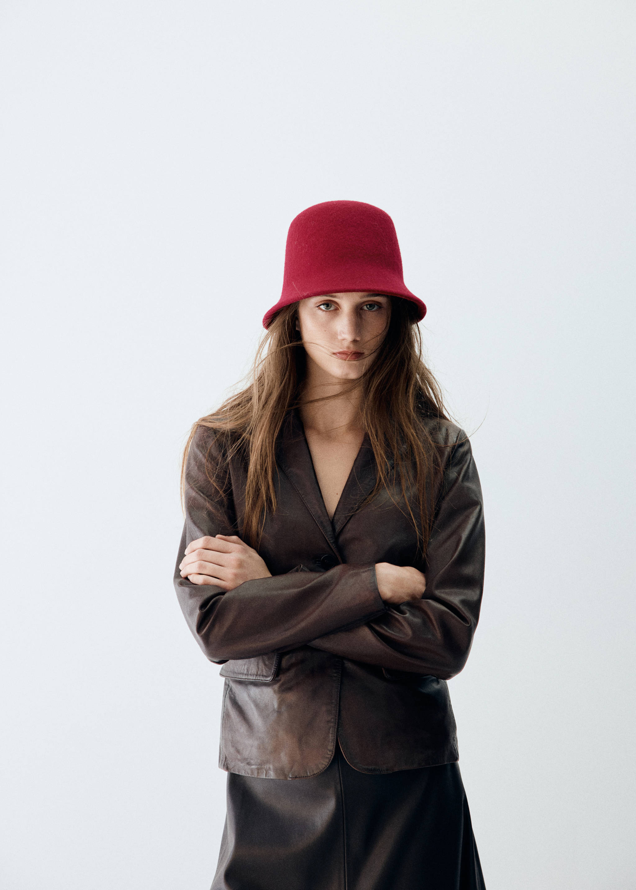 Red wool hat with a rounded crown and a short upturned brim.