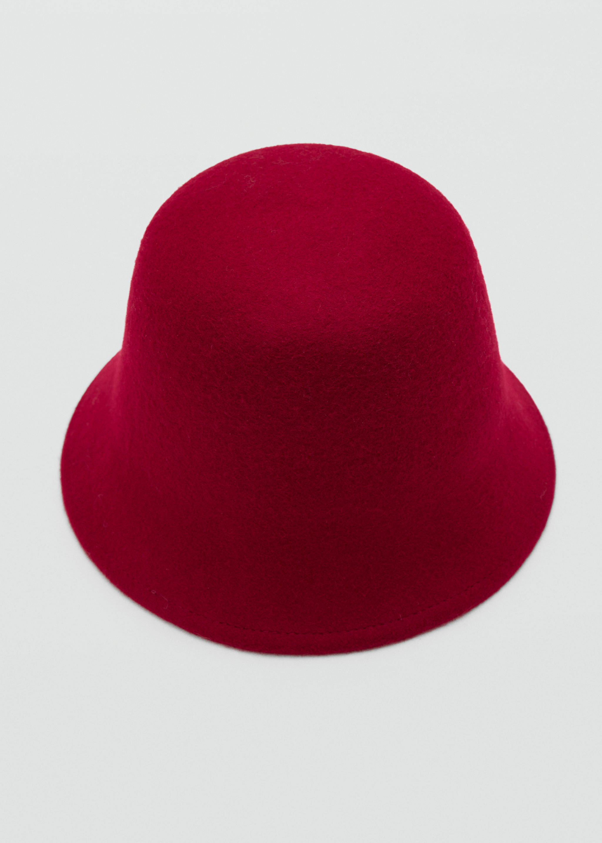 Red felt hat with a rounded crown and short downturned brim.