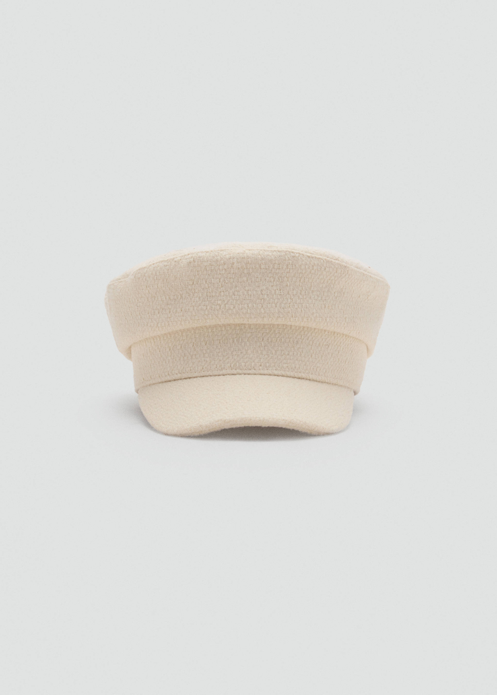 Cream sailor cap with a textured fabric and a structured brim.