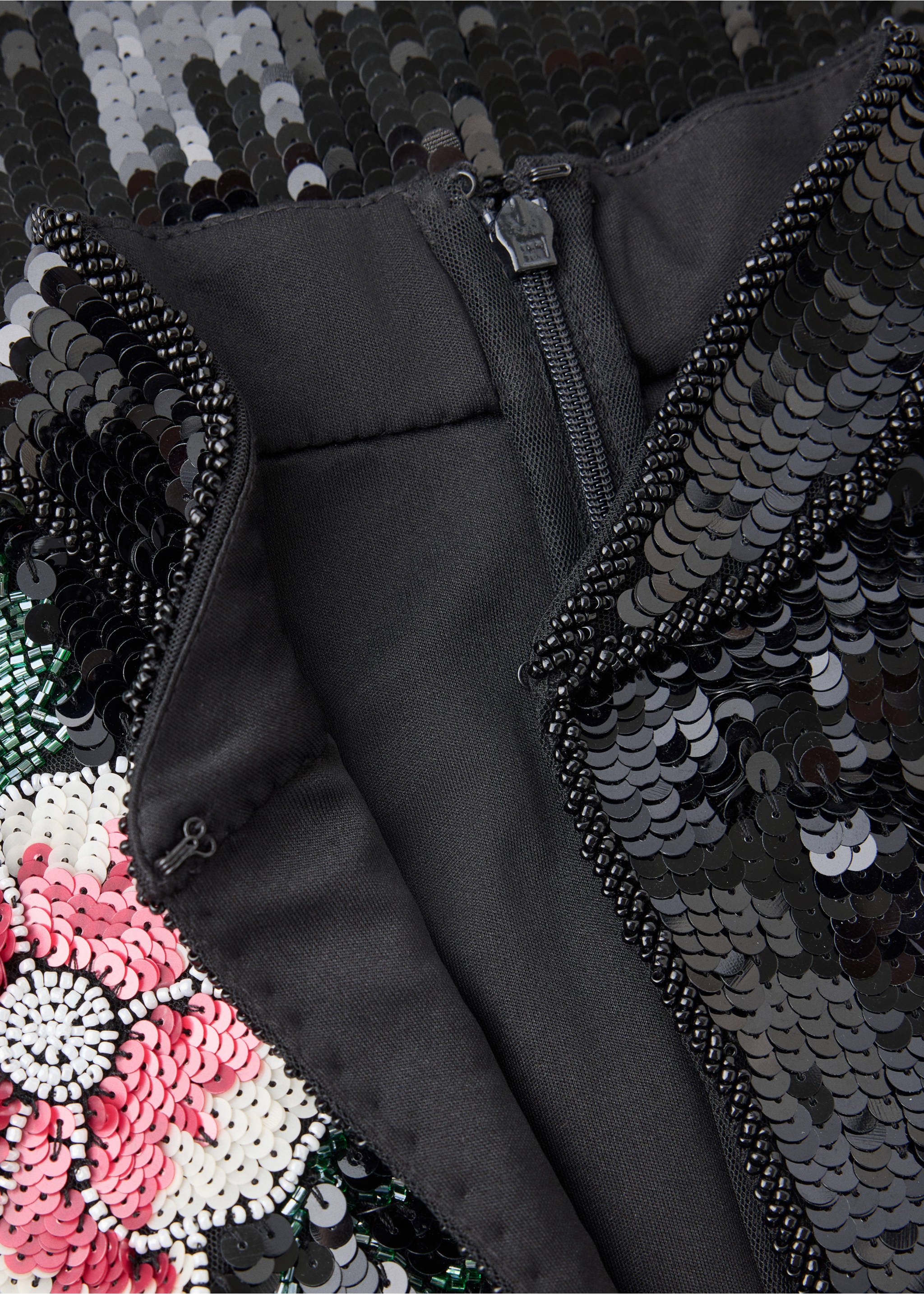 Close-up of the back zip and sequin floral embellishment on a black dress., Black. Ref: 47091366-00.