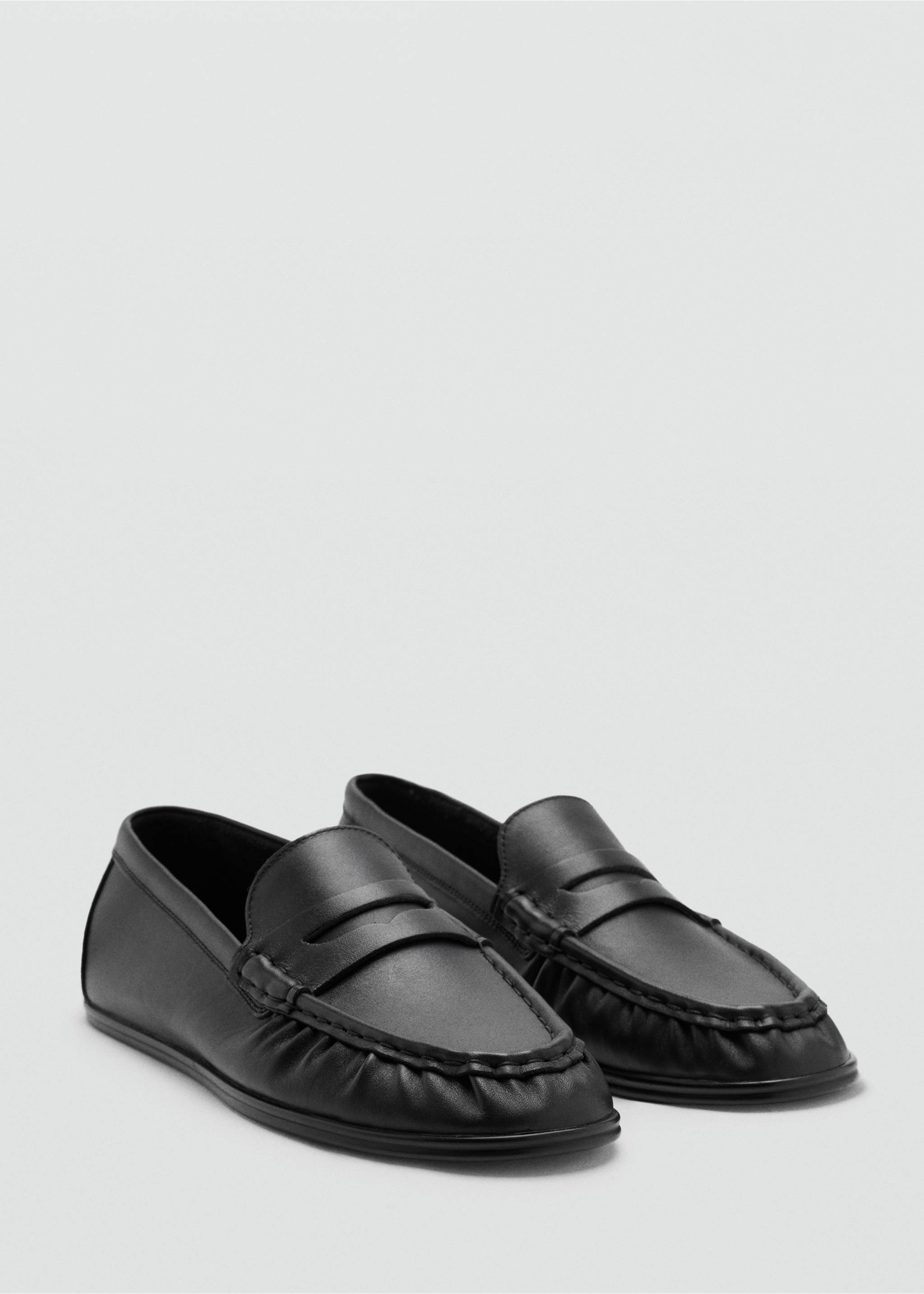 Black leather penny loafers with traditional moc-toe stitching and a saddle strap., Black. Ref: 47091370-00.