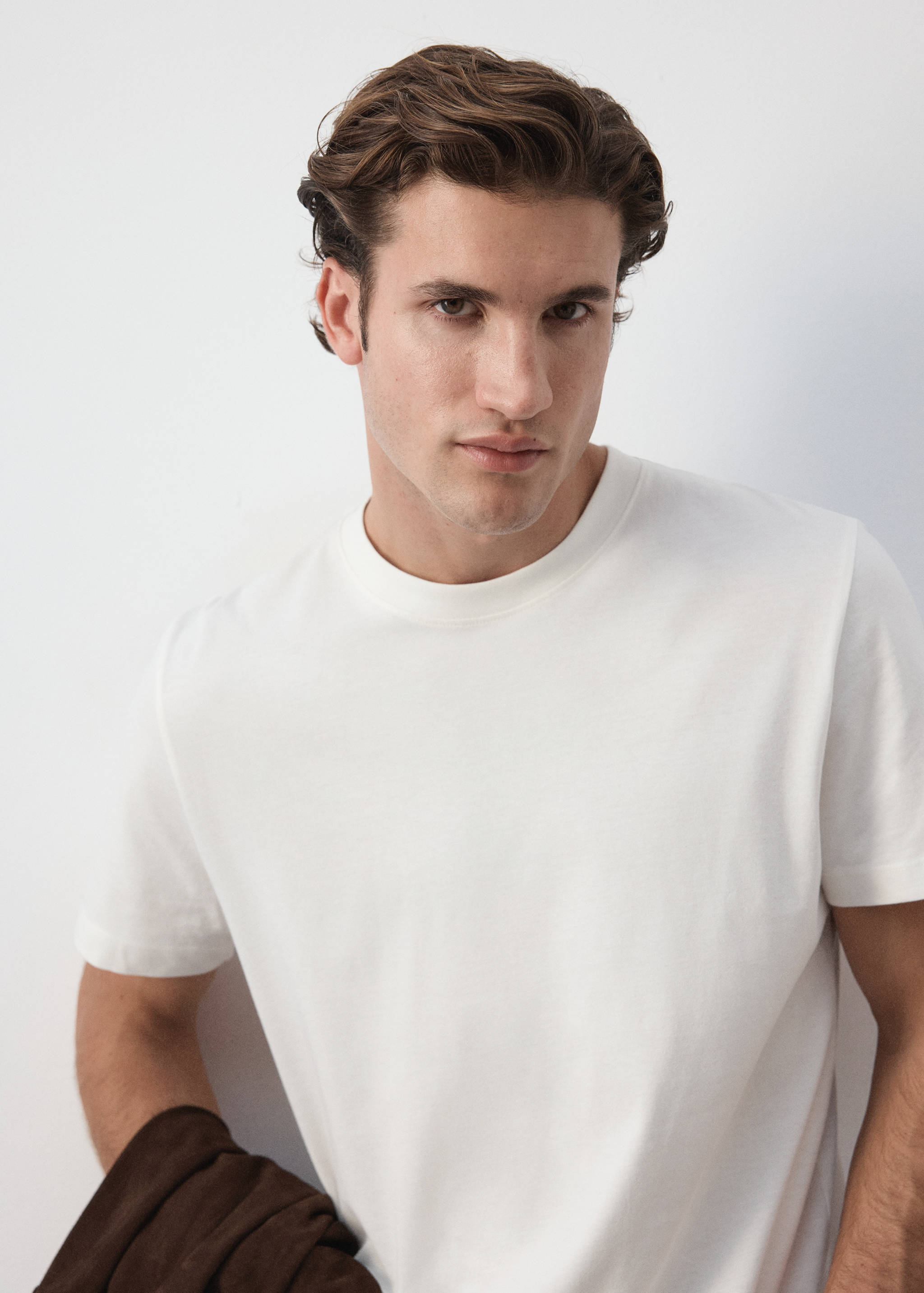 White crew neck t-shirt in a close-up portrait.