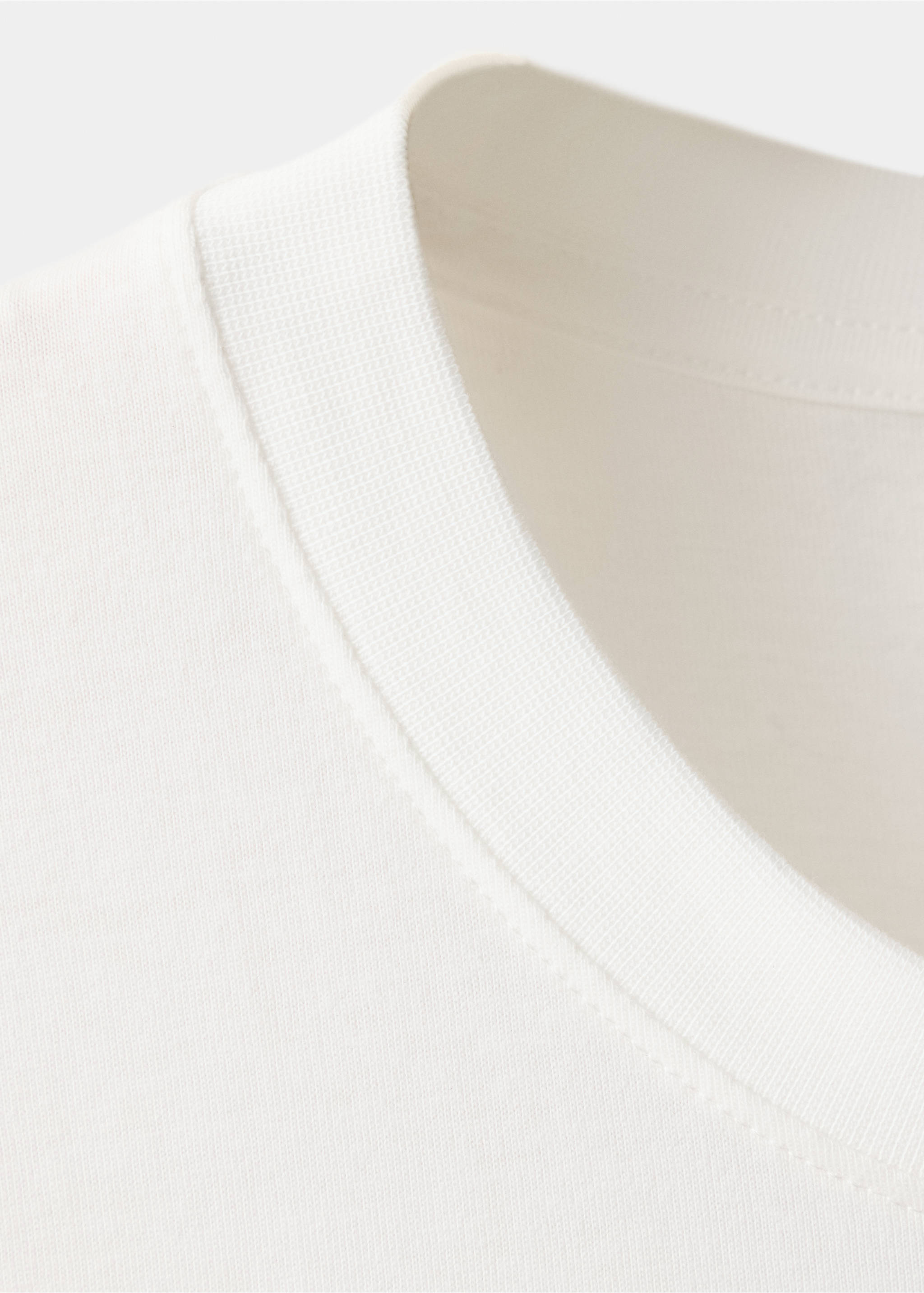 Close-up of an off-white men's t-shirt ribbed crew neckline., White. Ref: 47091412-00.