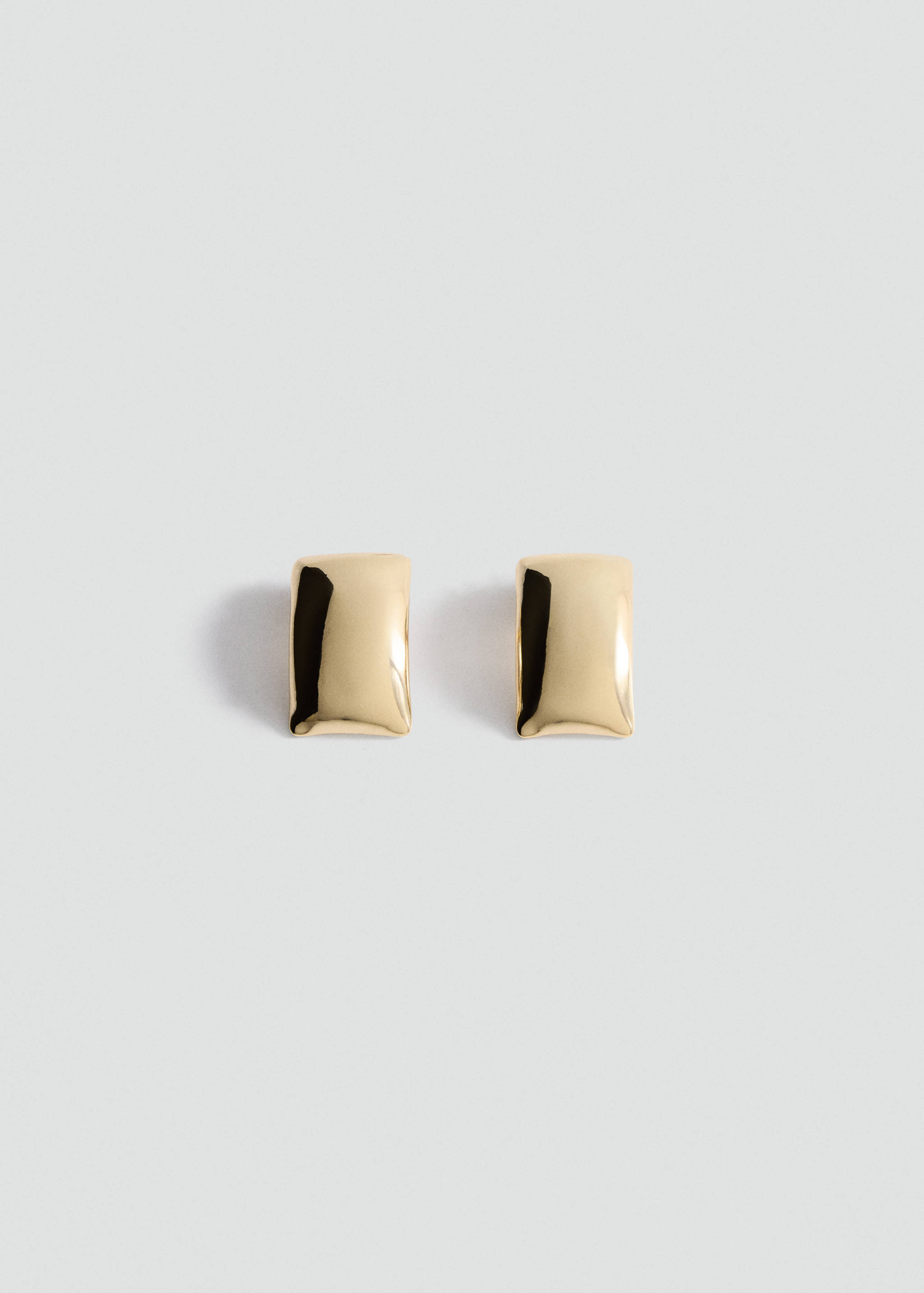 Pair of polished gold-coloured rectangular earrings on a light grey background.