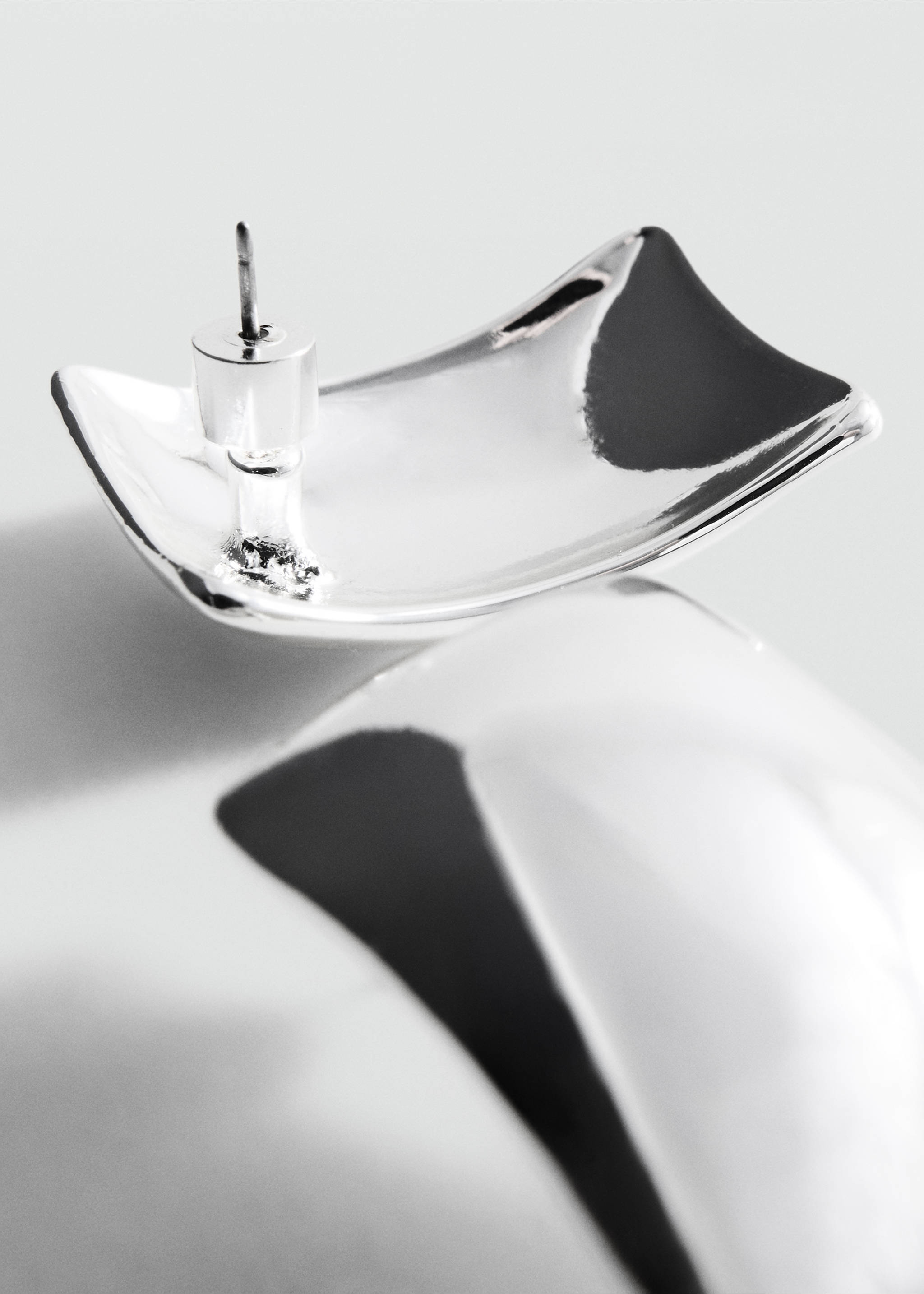 Silver-tone metallic earrings shown in a three-quarter close-up view., Silver. Ref: 47091449-00.
