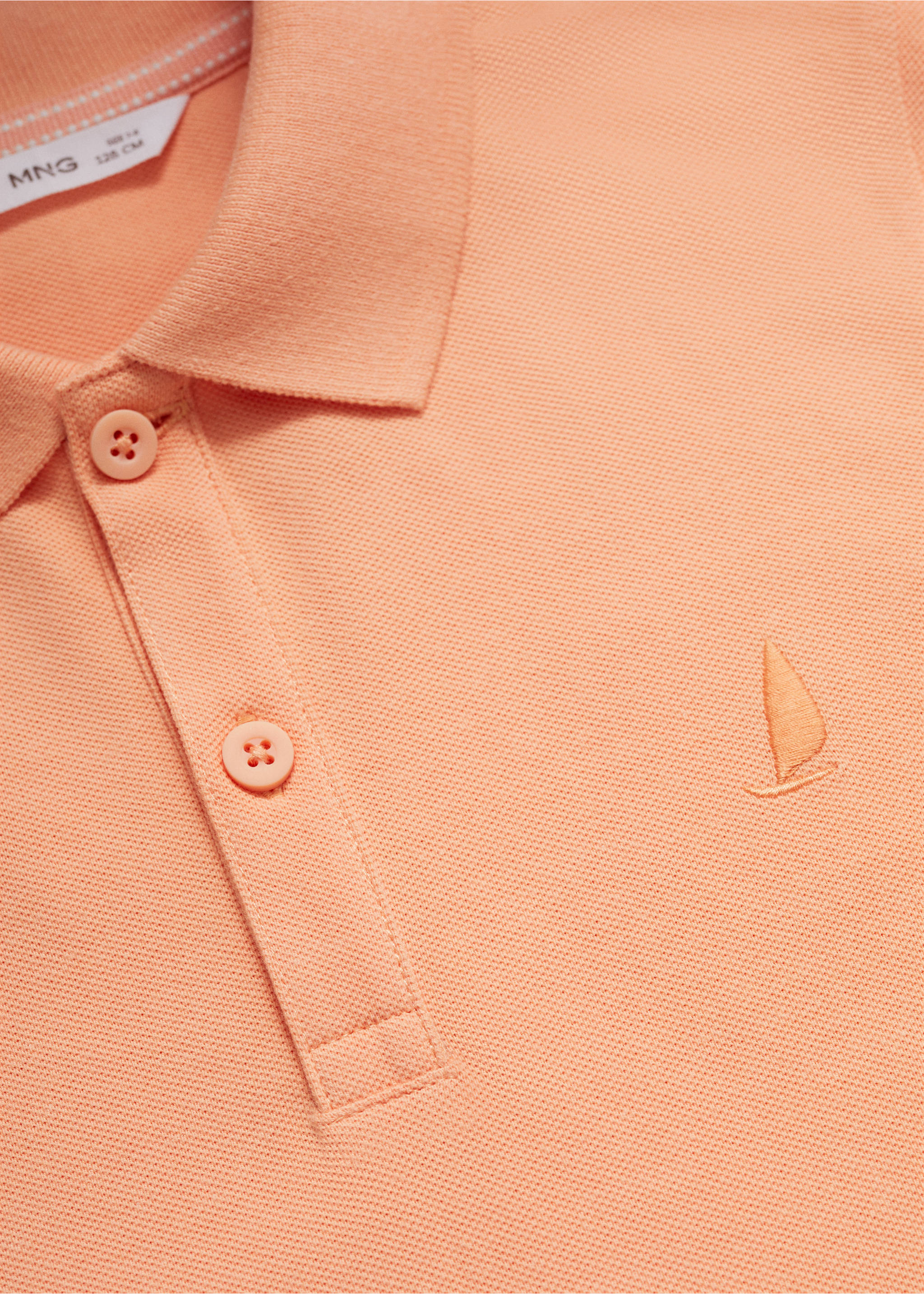 Polo 100 % coton - Détail de l'article 8, Orange pastel. Ref: 67075137-00.