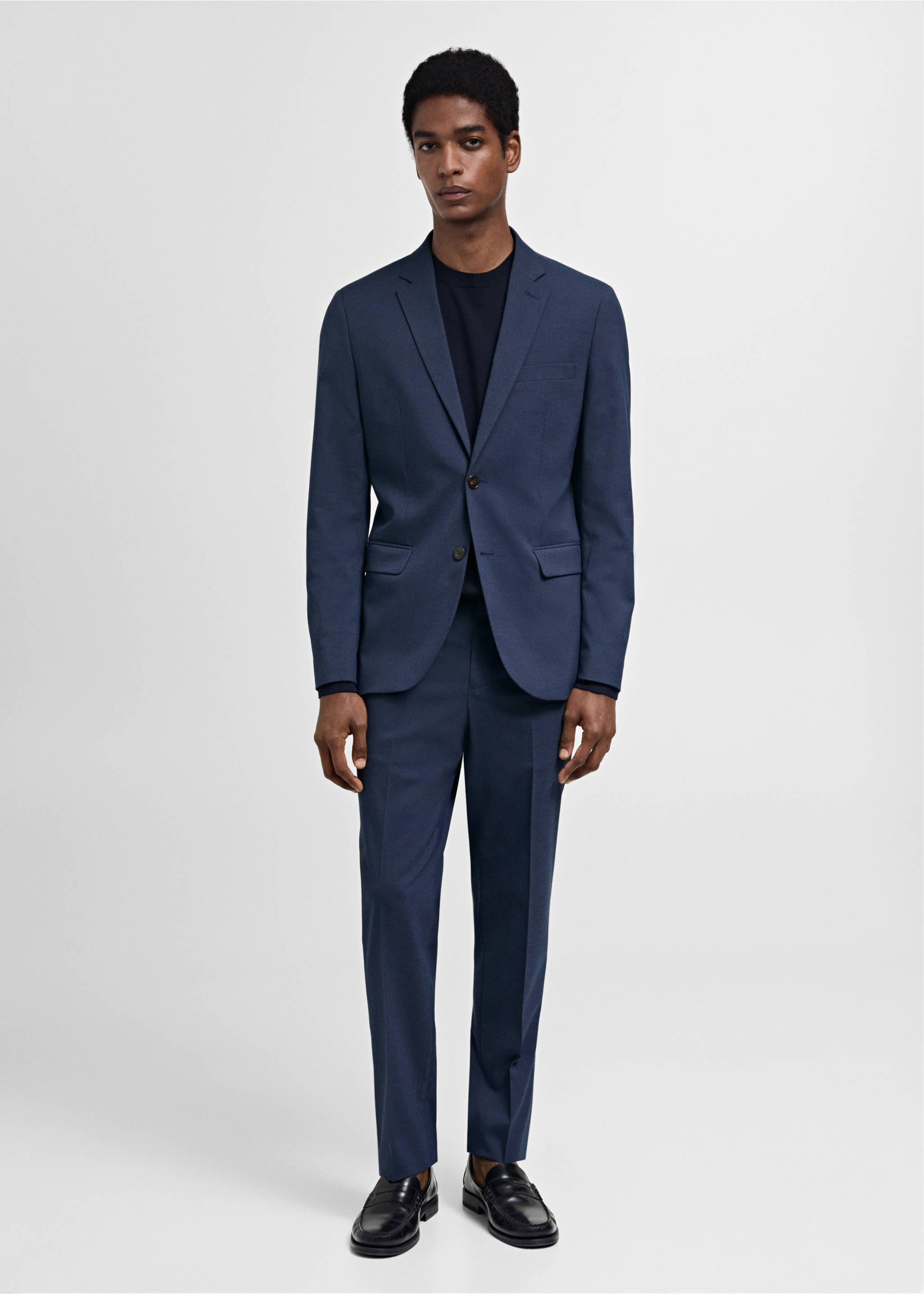 Navy blue trousers worn with a matching blazer, dark t-shirt, and black loafers., Ink Blue. Ref: 77000577-02.