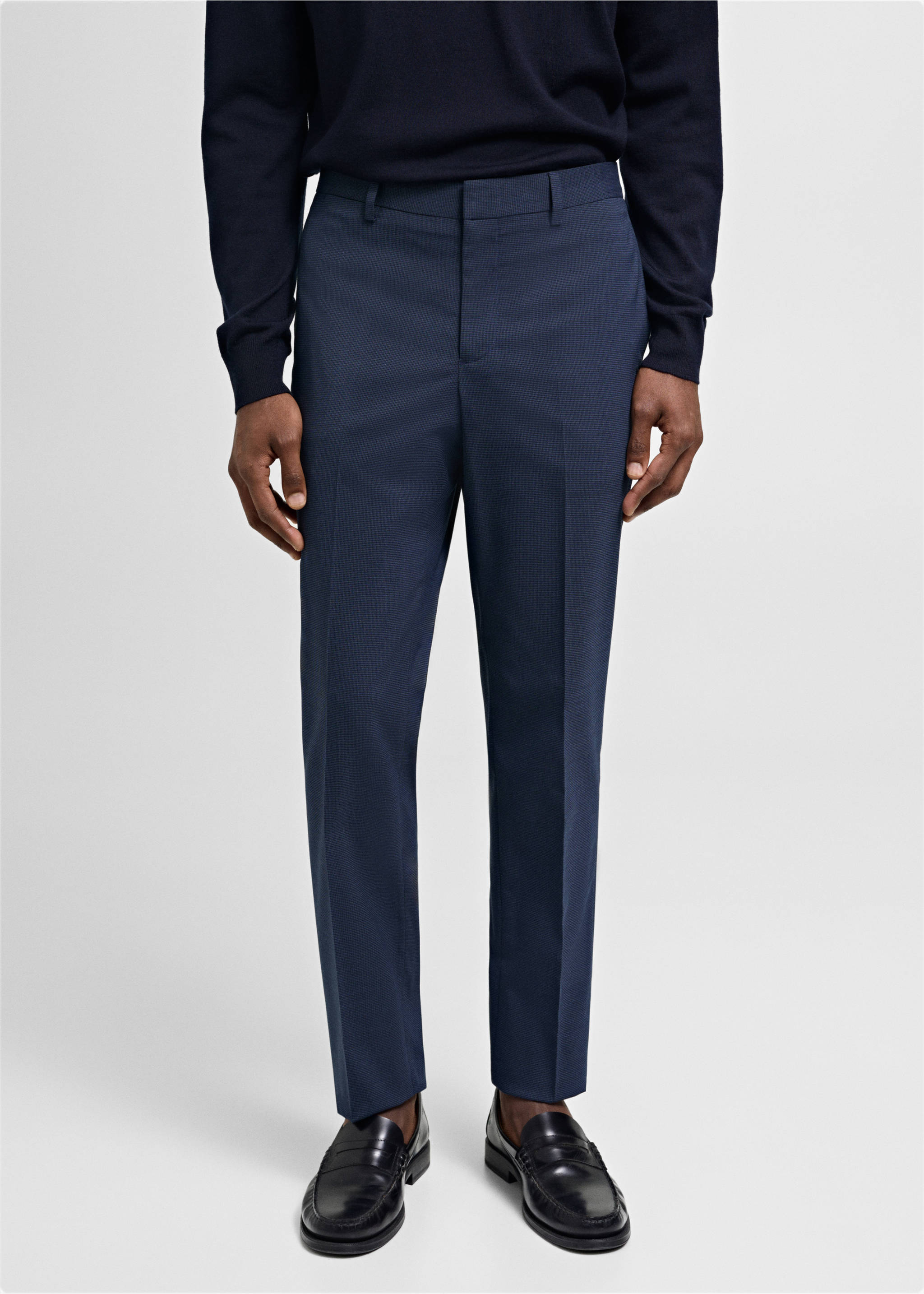 Dark navy blue tailored trousers with centre creases worn with a dark sweater., Ink Blue. Ref: 77000577-02.