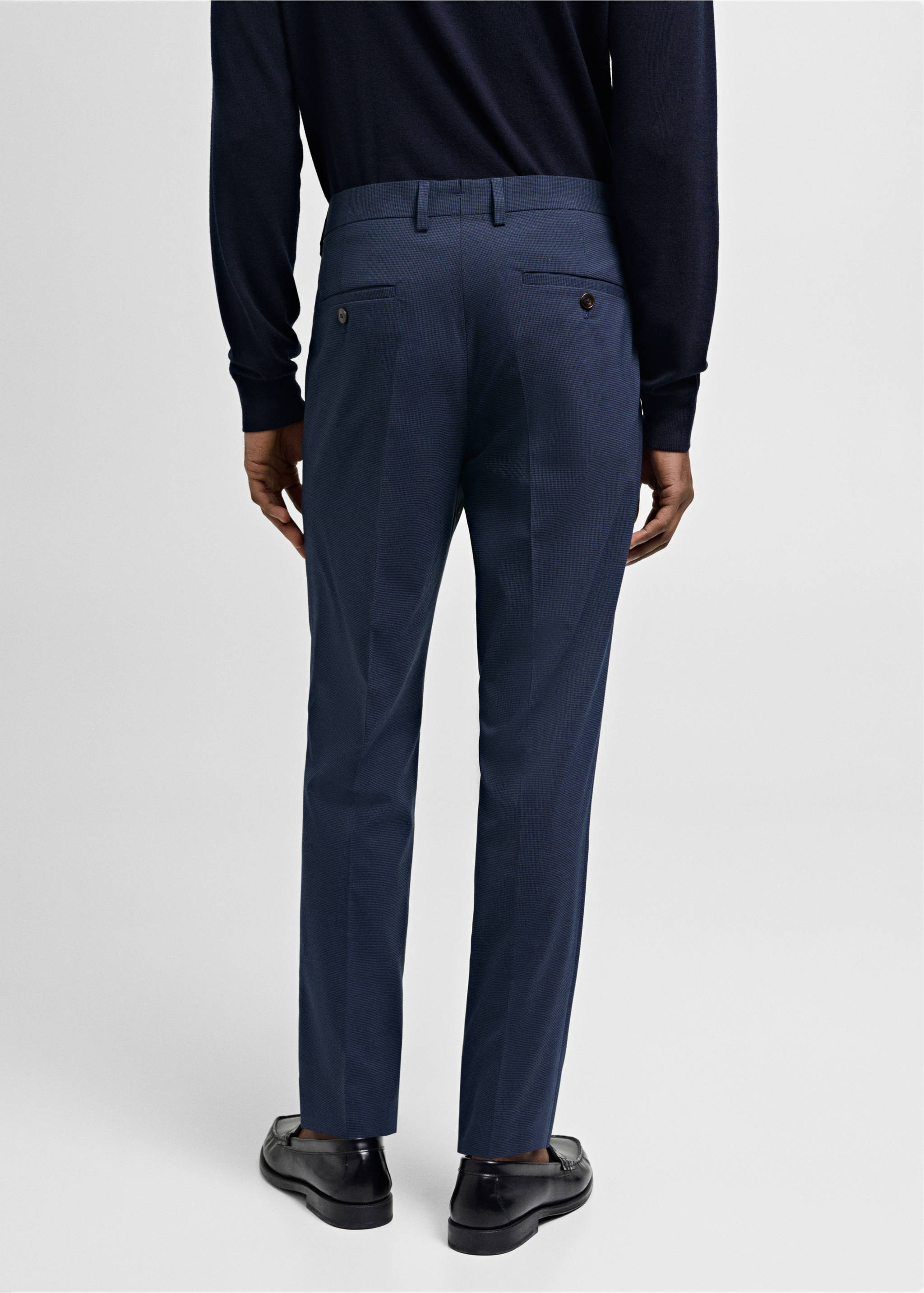 Navy blue trousers seen from the back, featuring belt loops and back welt pockets., Ink Blue. Ref: 77000577-02.