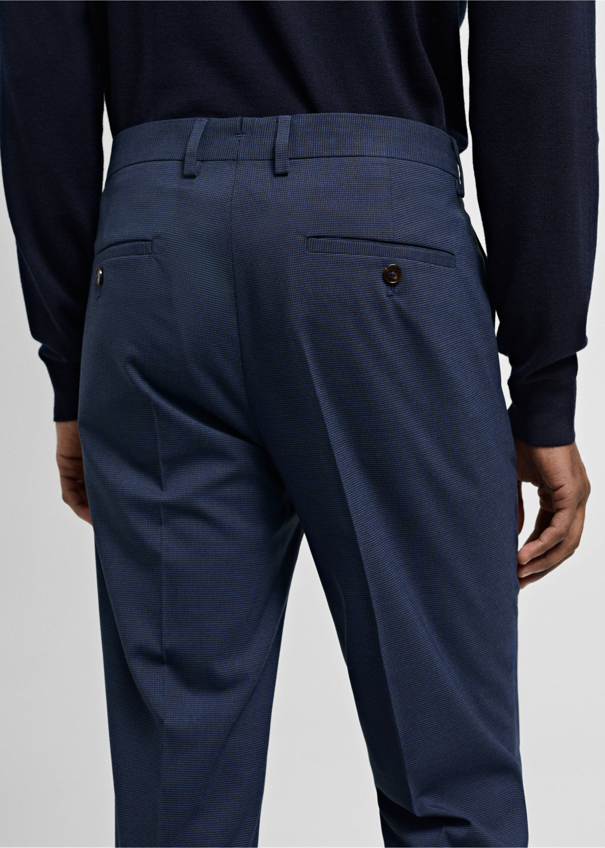 Navy blue trousers featuring belt loops and buttoned back pockets, back view., Ink Blue. Ref: 77000577-02.