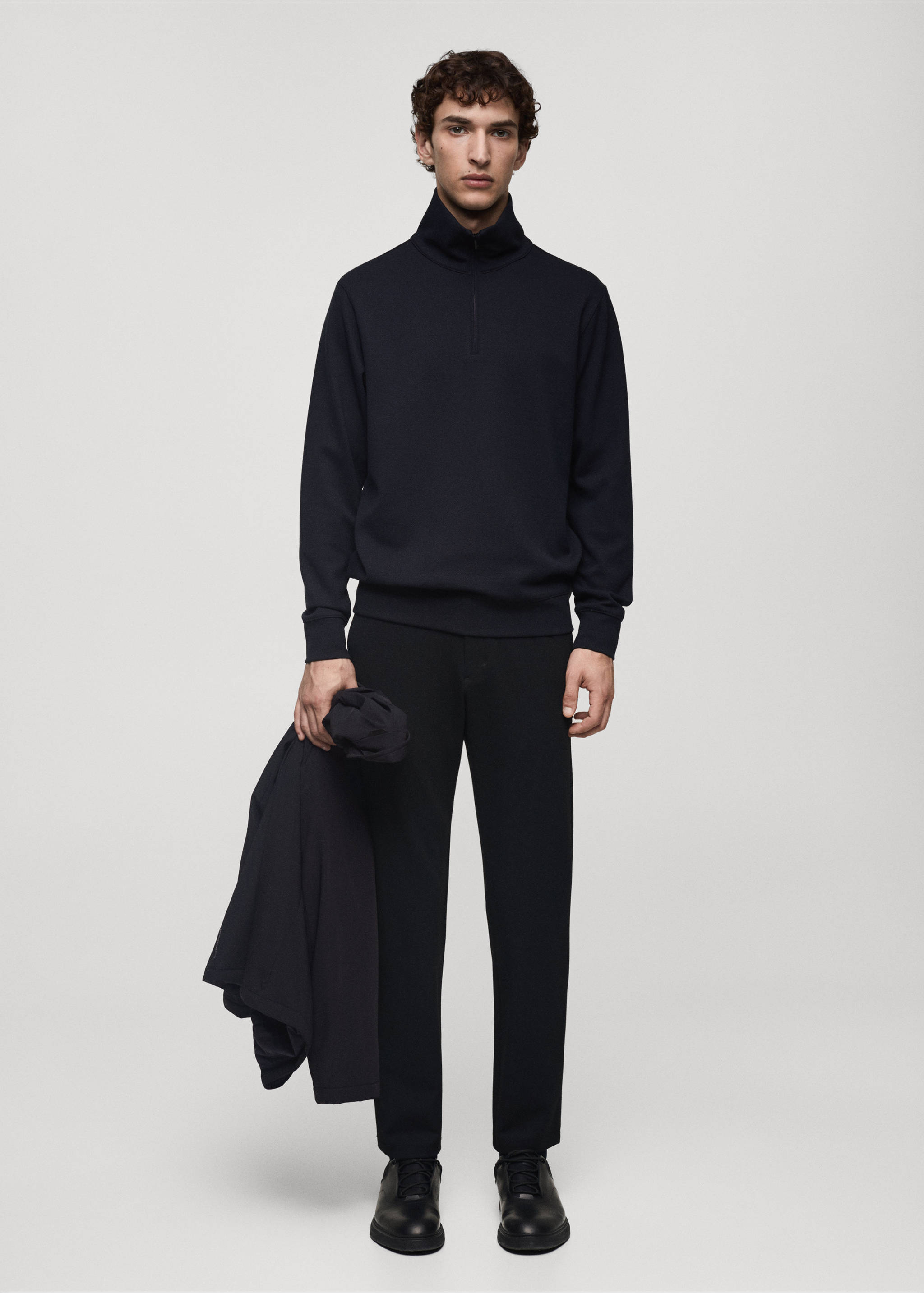 Navy blue zip-neck sweatshirt with a high collar, worn with dark trousers., Dark Navy. Ref: 77025969-00.