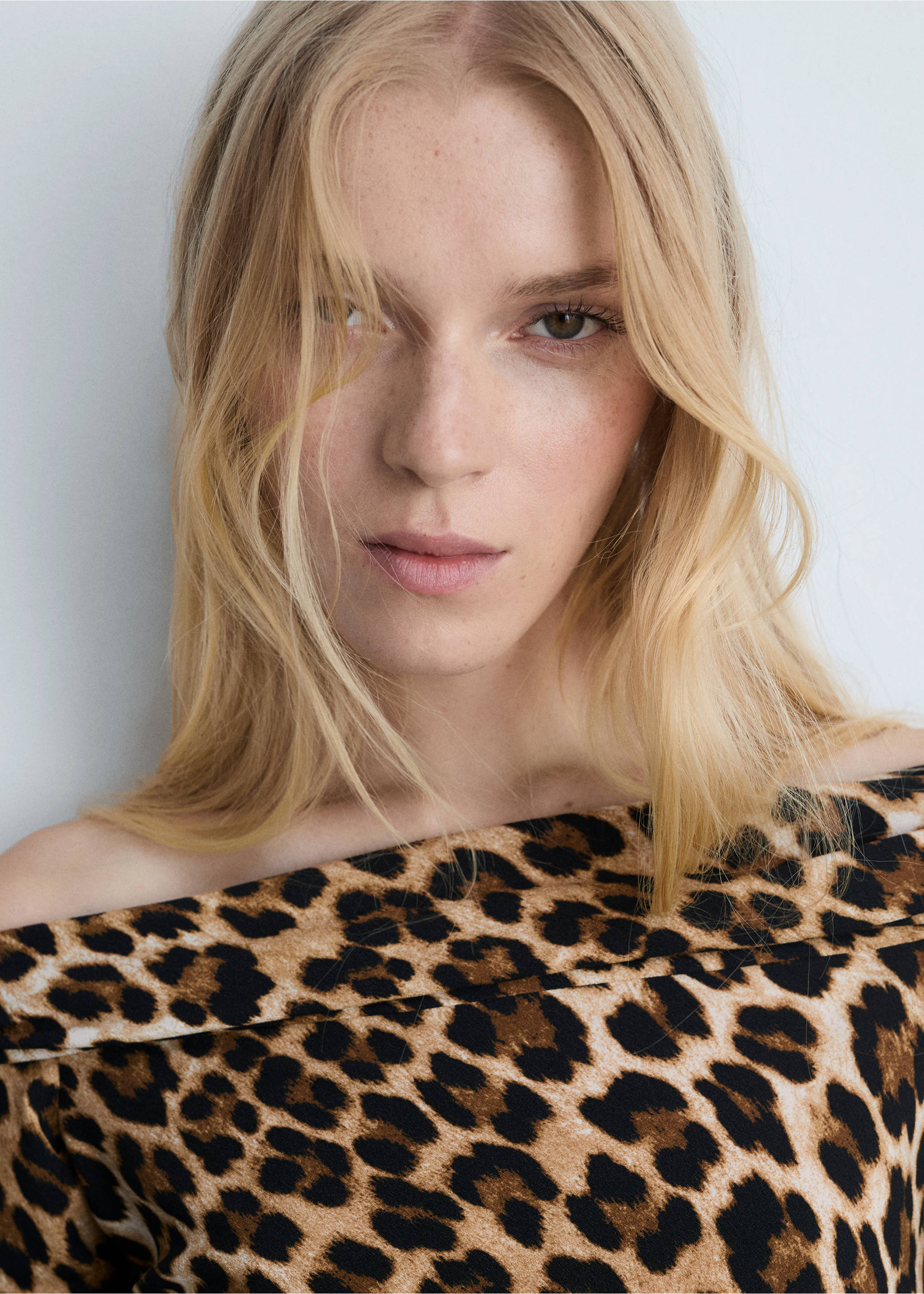 Close-up of a leopard-print dress with an off-the-shoulder neckline., Brown. Ref: 77035673-00.