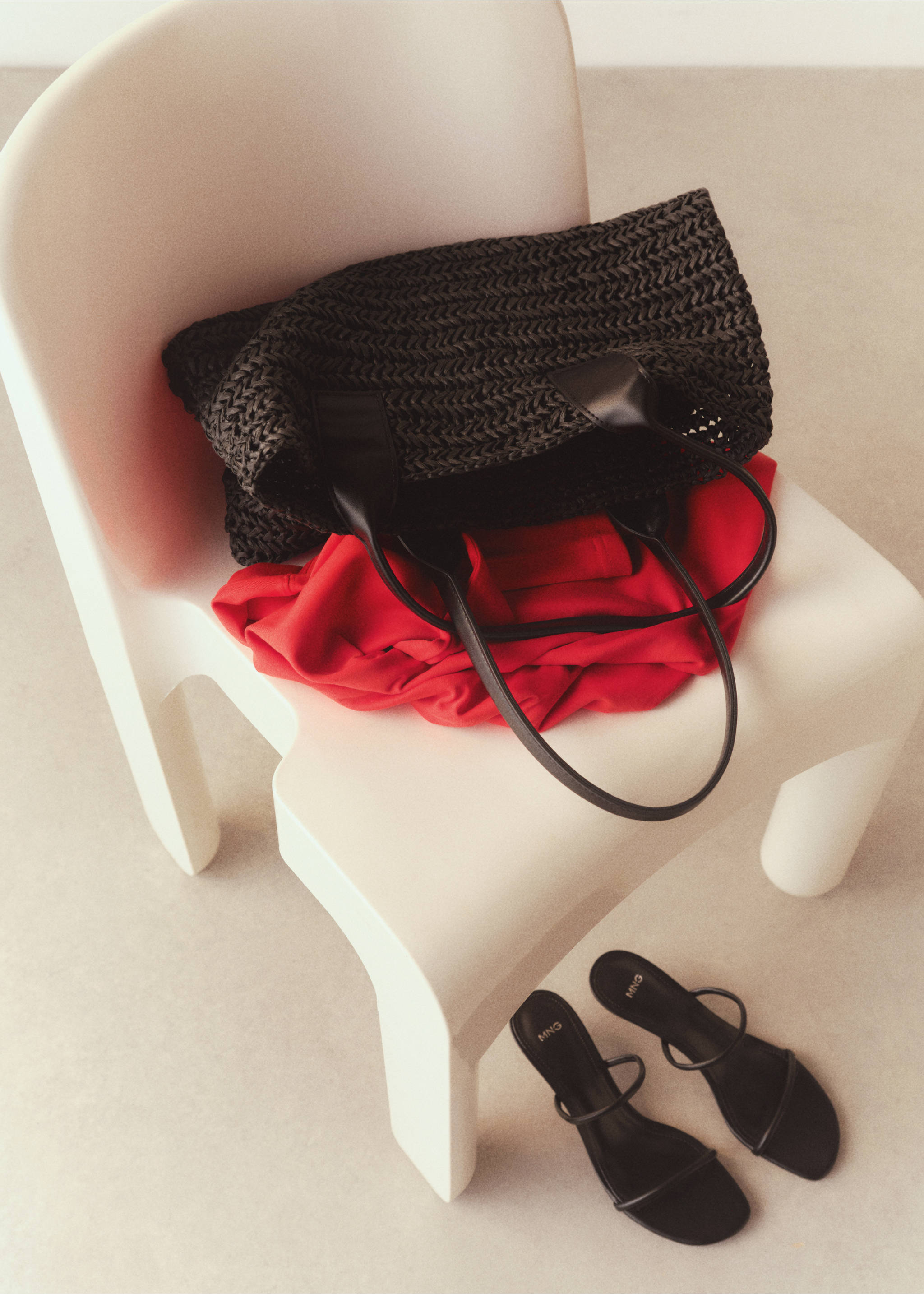 Dark woven tote bag resting on a white chair., Black. Ref: 77050349-00.