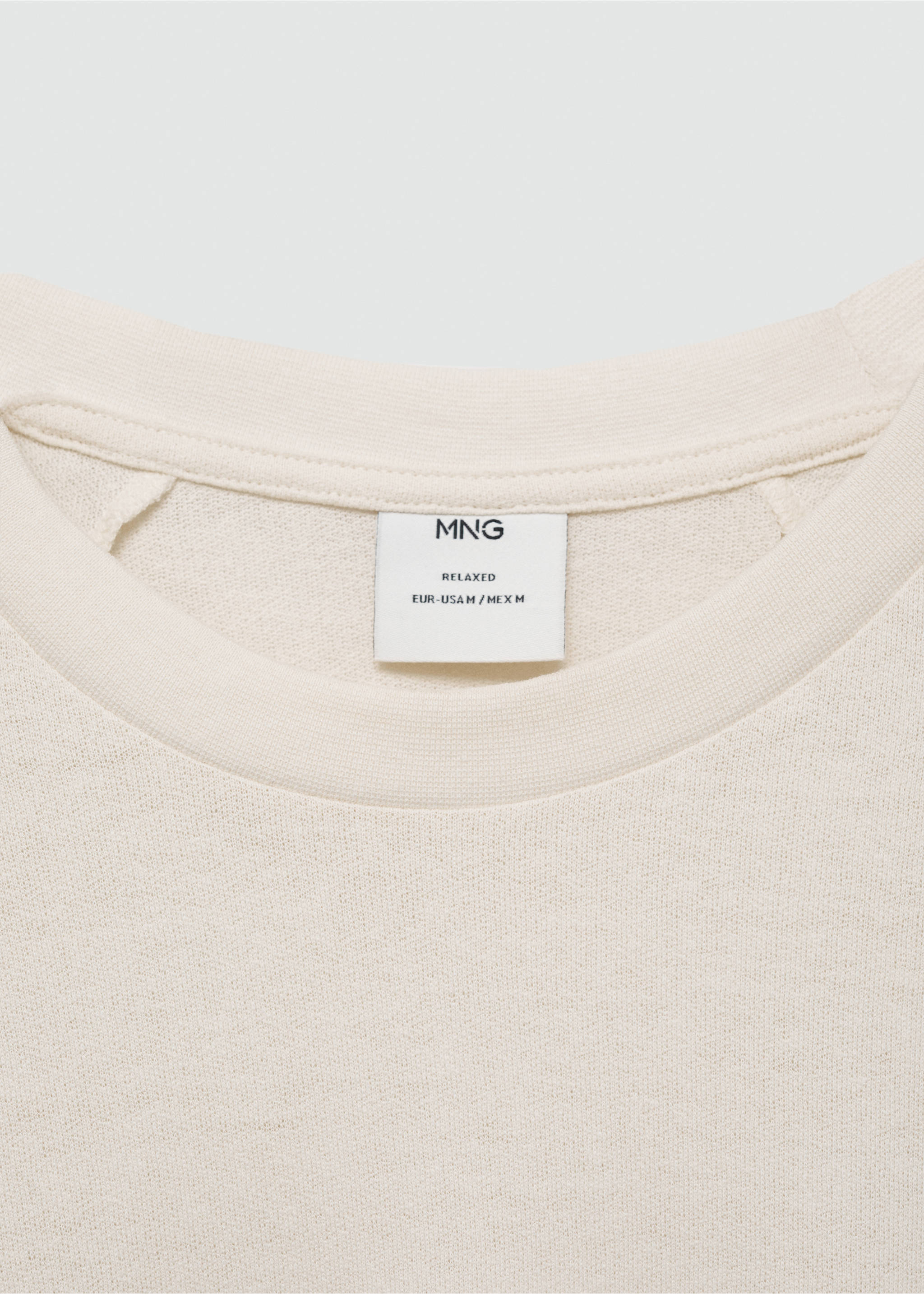 Close-up of an off-white t-shirt collar showing the brand label., Ecru. Ref: 77060356-00.
