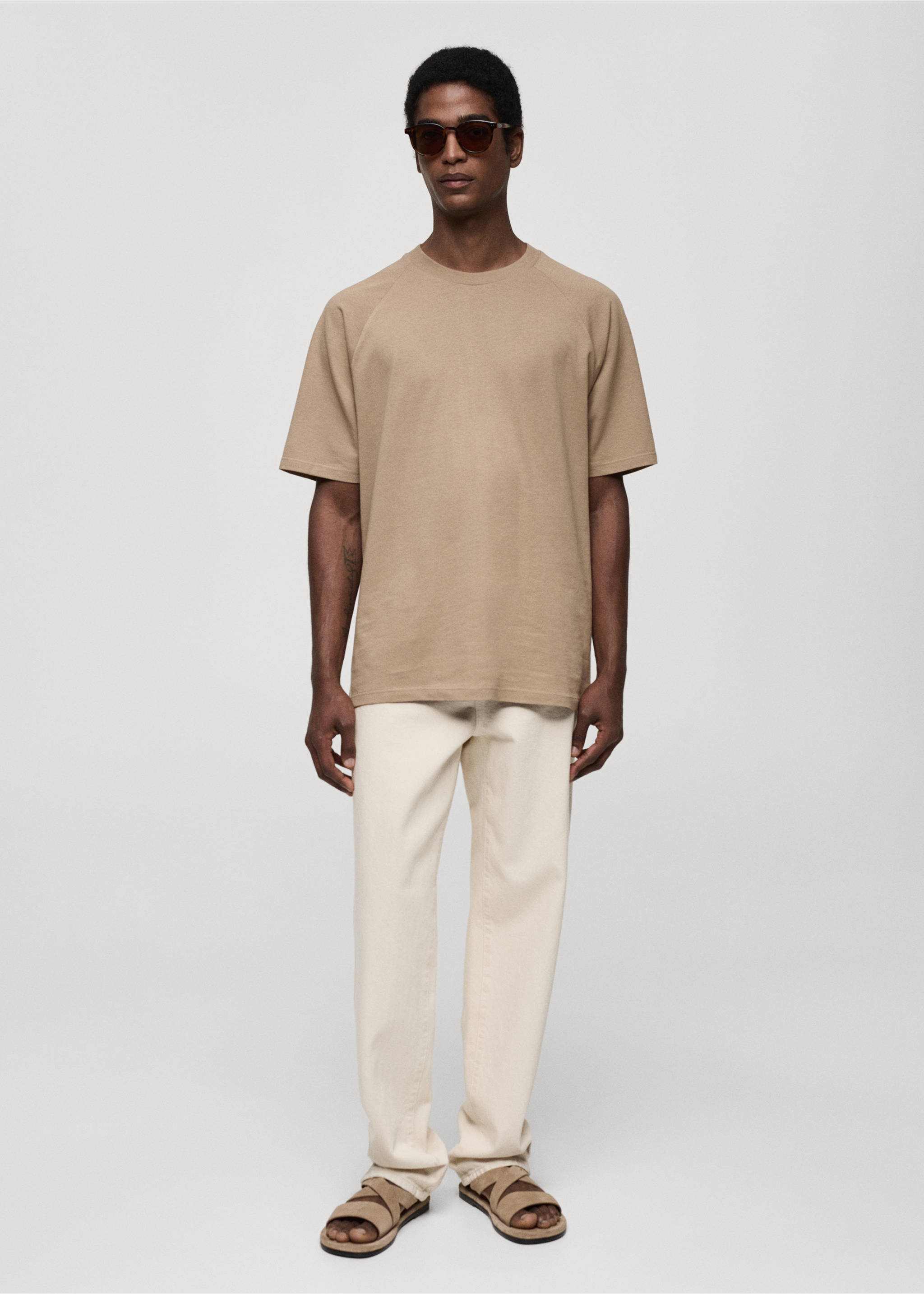 Beige short-sleeved t-shirt with a crew neck, worn with cream trousers., Beige. Ref: 77060356-00.