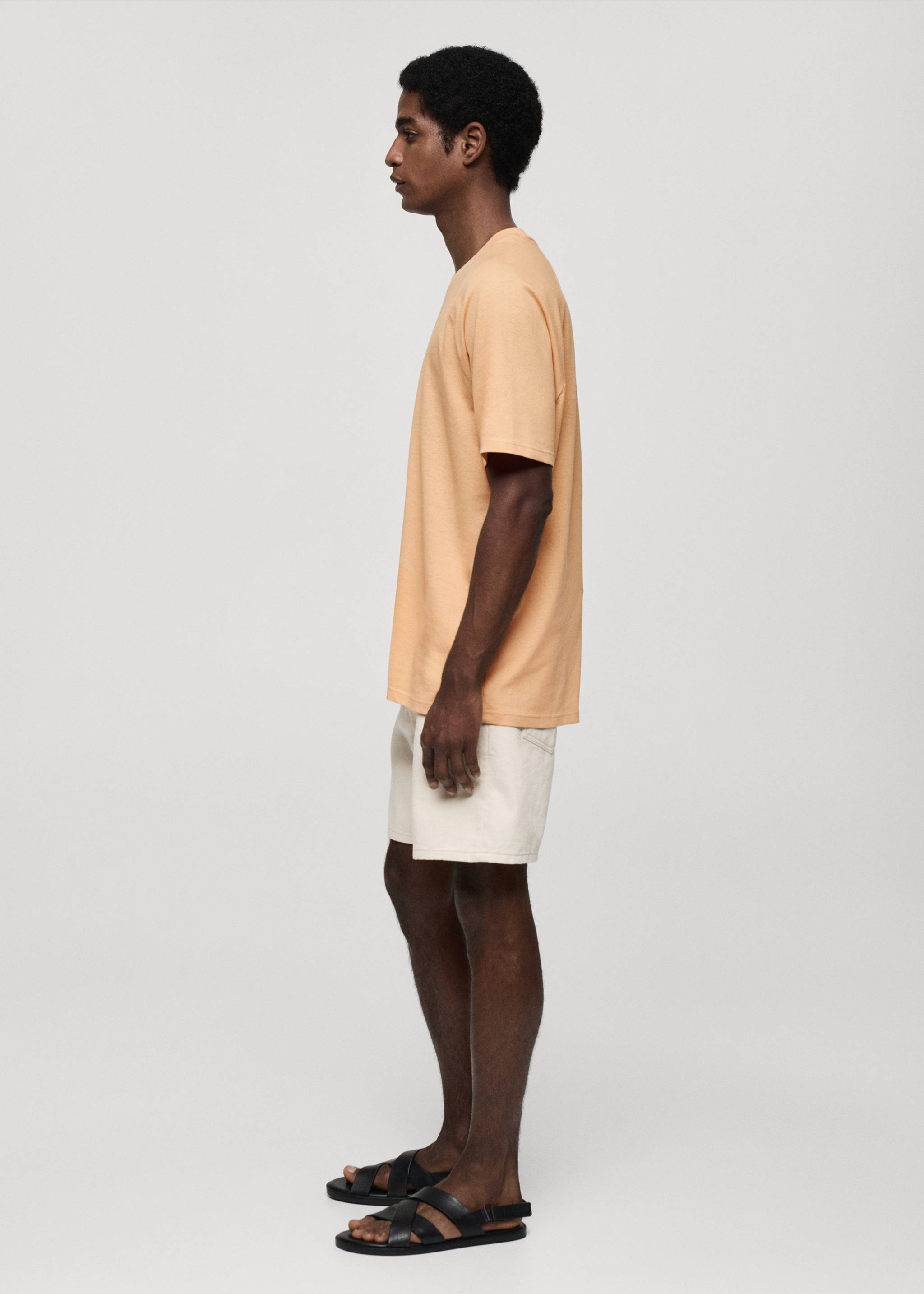 Peach short-sleeved t-shirt with a round neck, worn with off-white shorts., Orange. Ref: 77060356-00.