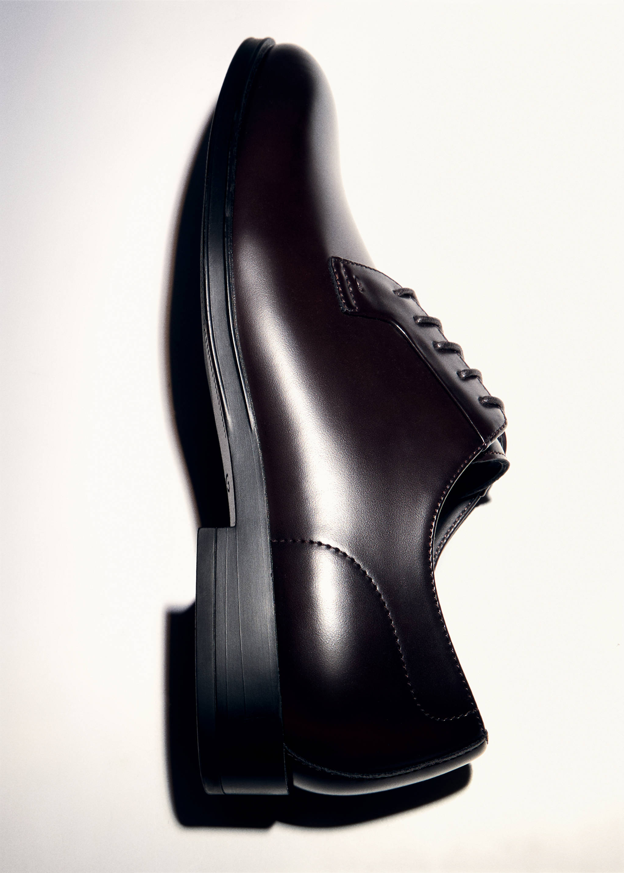 Dark brown leather derby shoe with a low block heel.