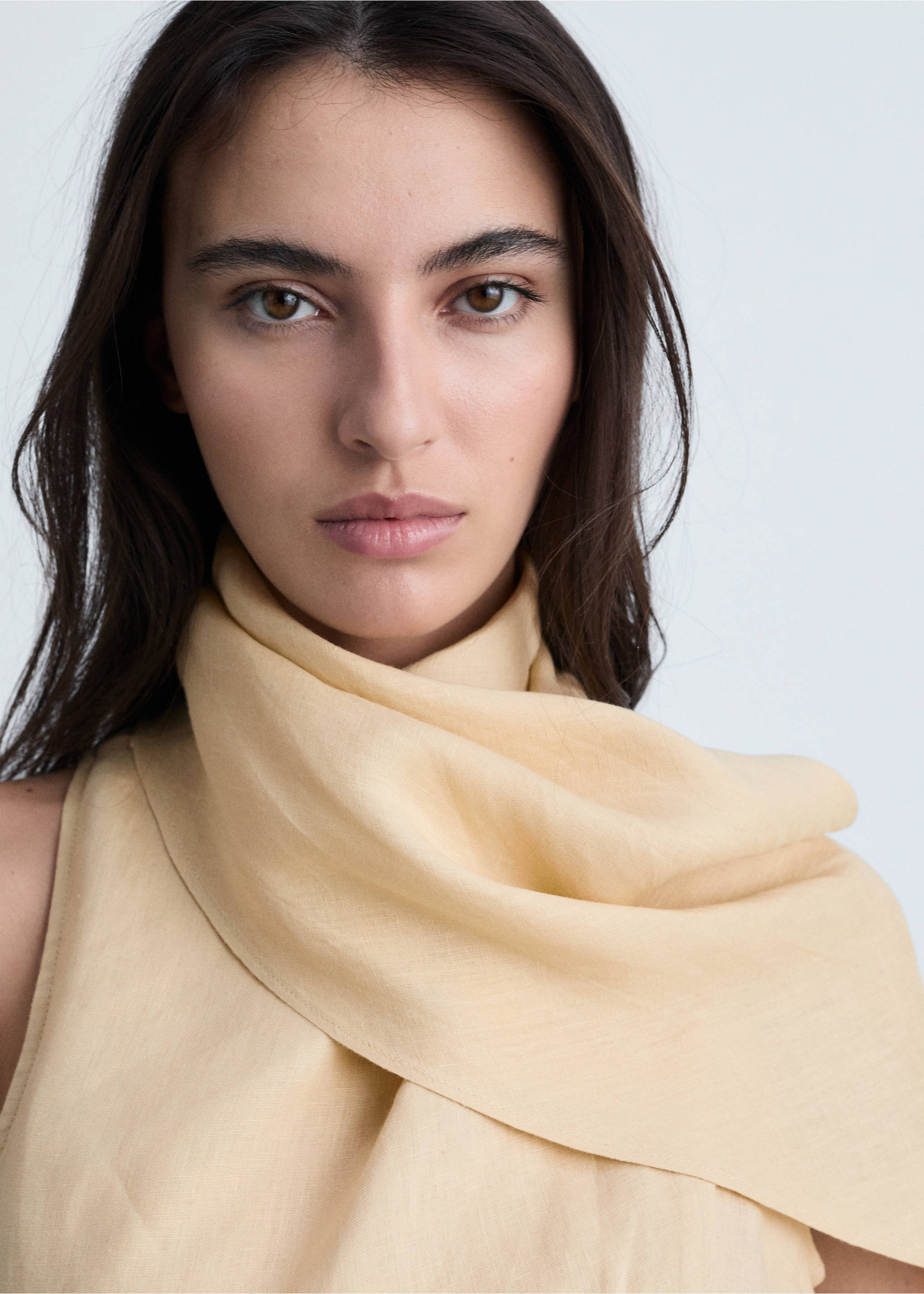Pale yellow dress with a draped scarf neckline, shown in a close-up., Sand. Ref: 87004783-00.