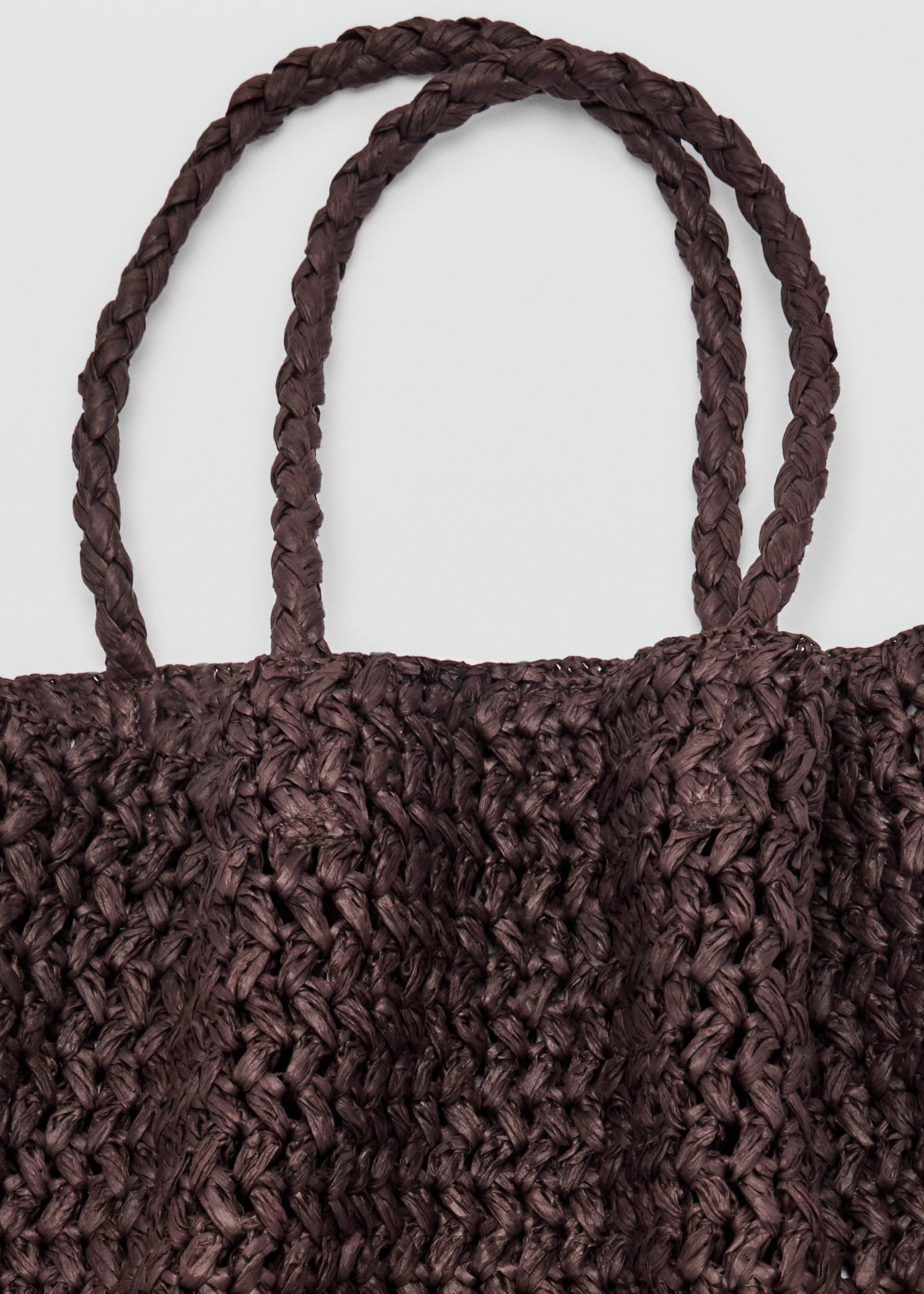 Dark brown woven bag with braided top handles.