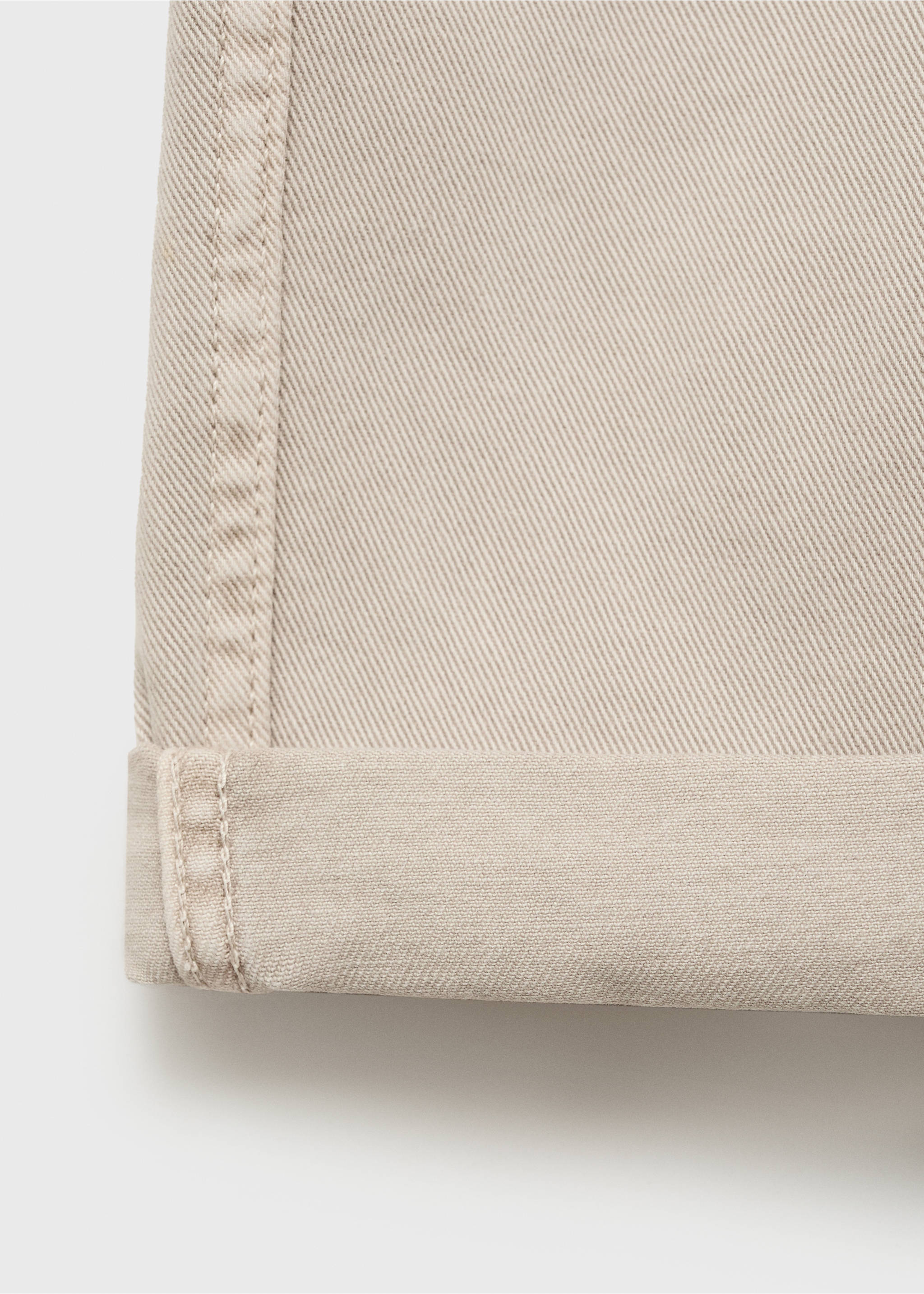Close-up of beige bermuda shorts showing the twill fabric and turned-up hem., Sand. Ref: 87007893-00.
