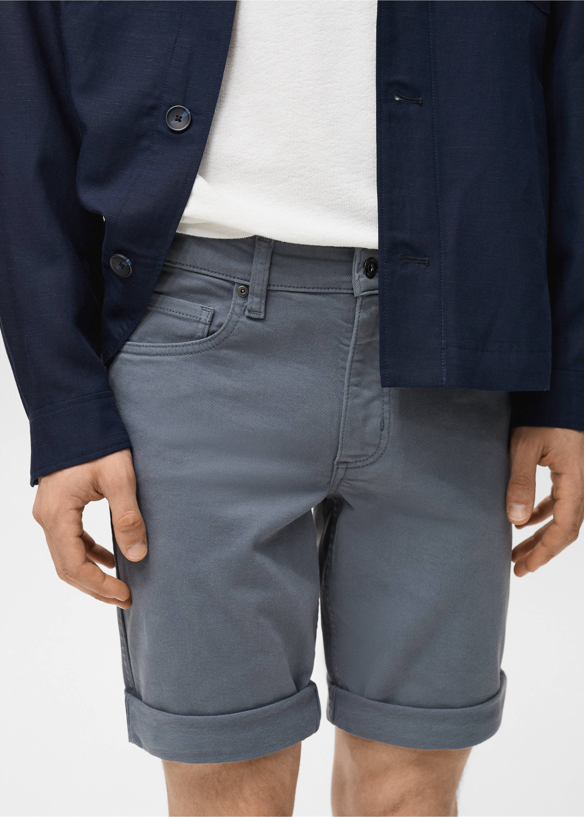 Grey bermuda shorts with cuffed hems, worn with a white t-shirt and navy overshirt., Indigo Blue. Ref: 87007893-00.