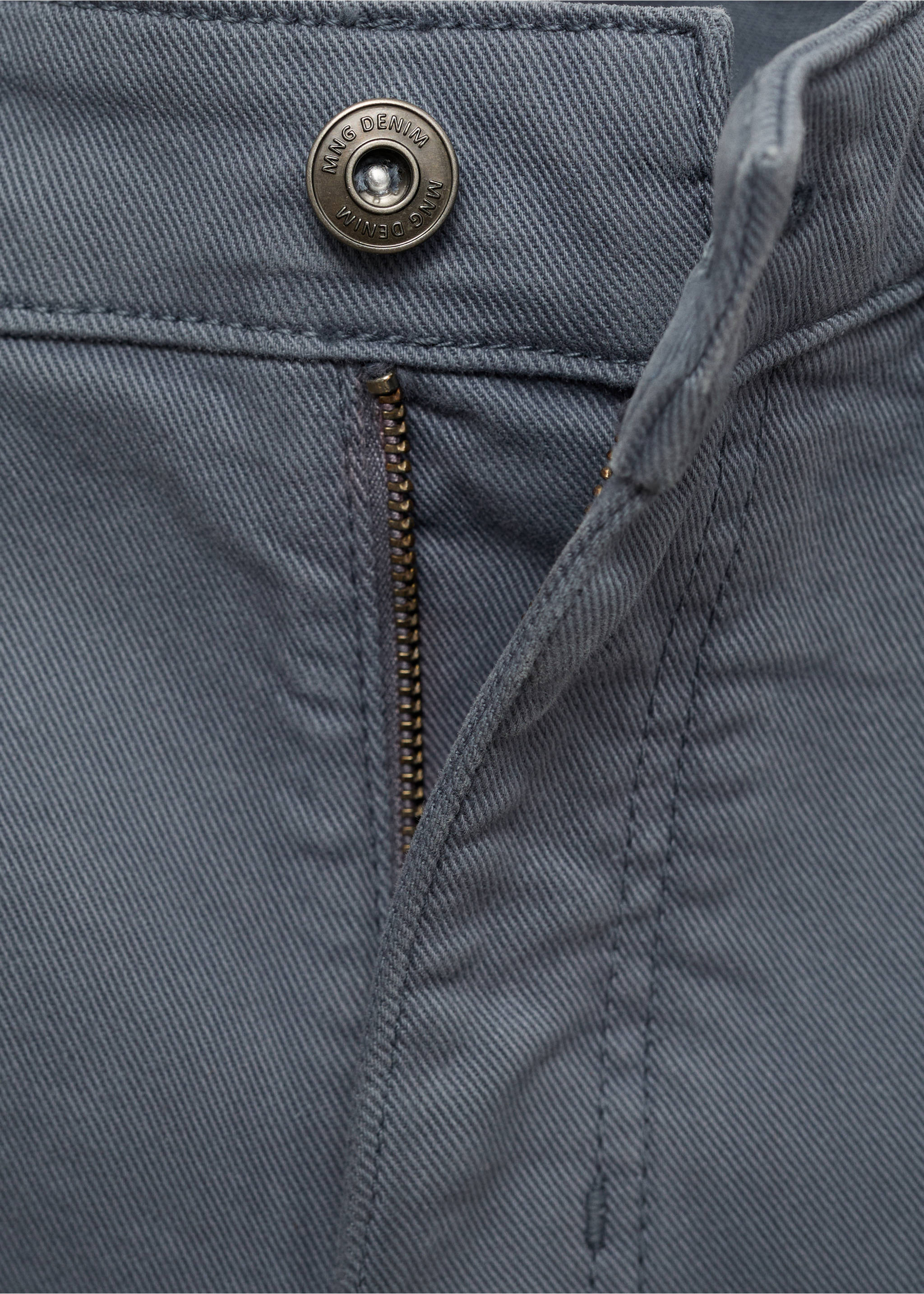 Close-up of grey denim bermuda shorts button fly and fabric detail., Indigo Blue. Ref: 87007893-00.