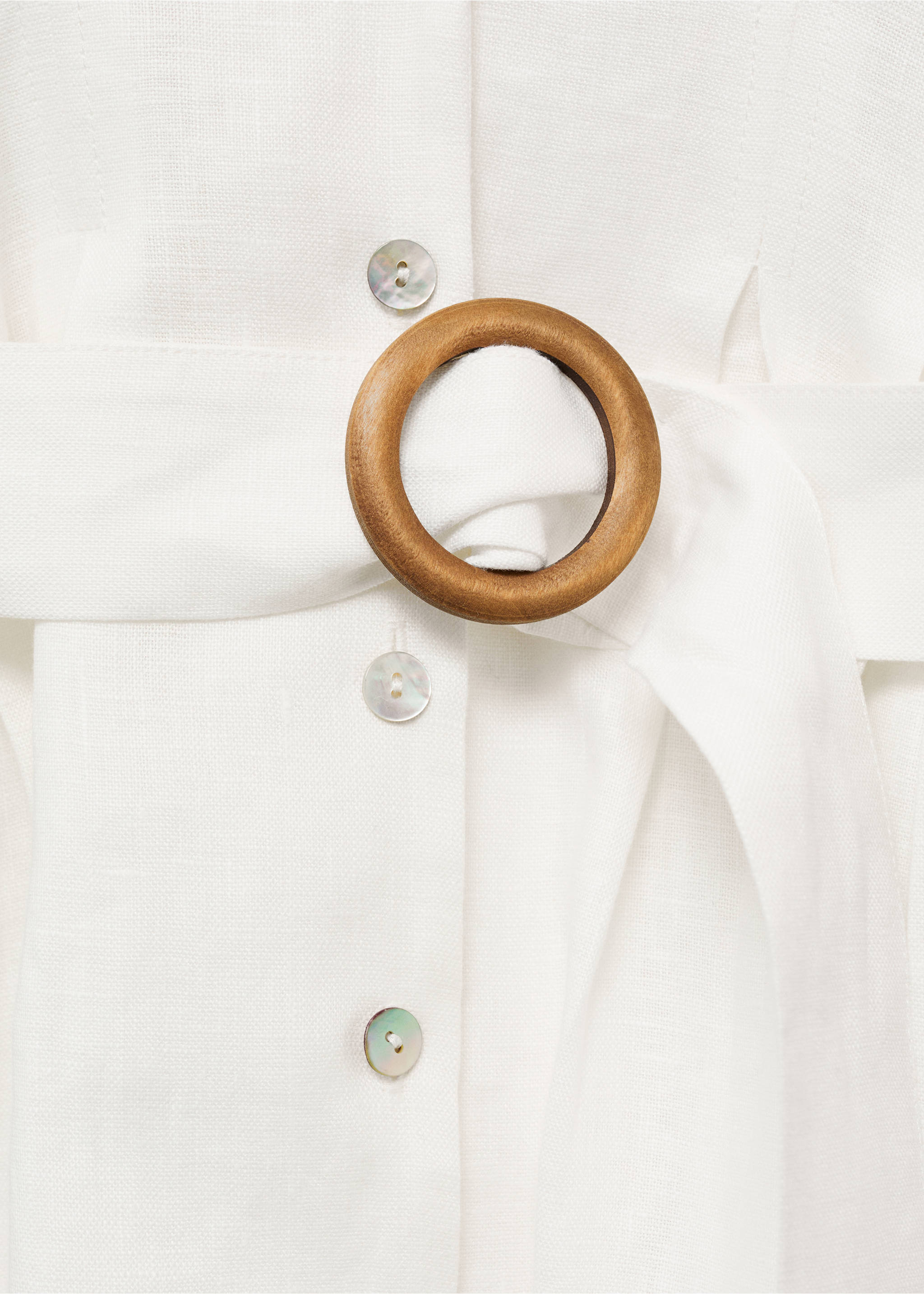 White dress detail featuring a wooden round belt buckle and buttons., White. Ref: 87017166-00.
