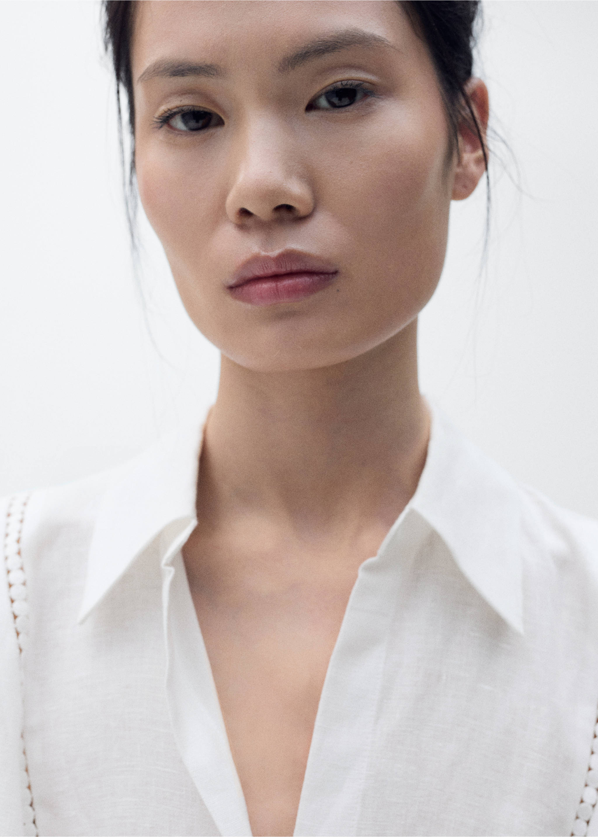Close-up of a white dress with a collared V-neck and trim detail., White. Ref: 87018644-00.