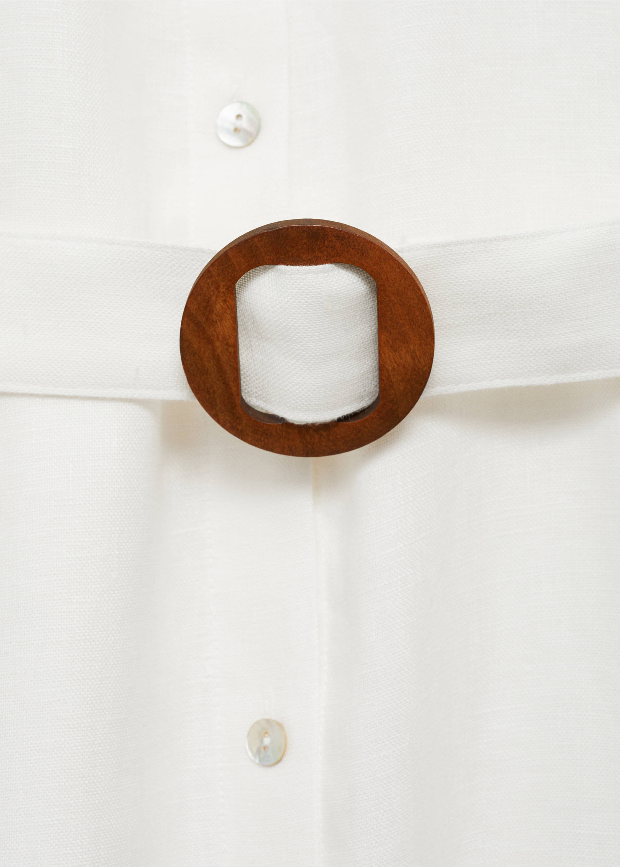 White dress detail featuring a fabric belt with a round wooden buckle., White. Ref: 87018644-00.