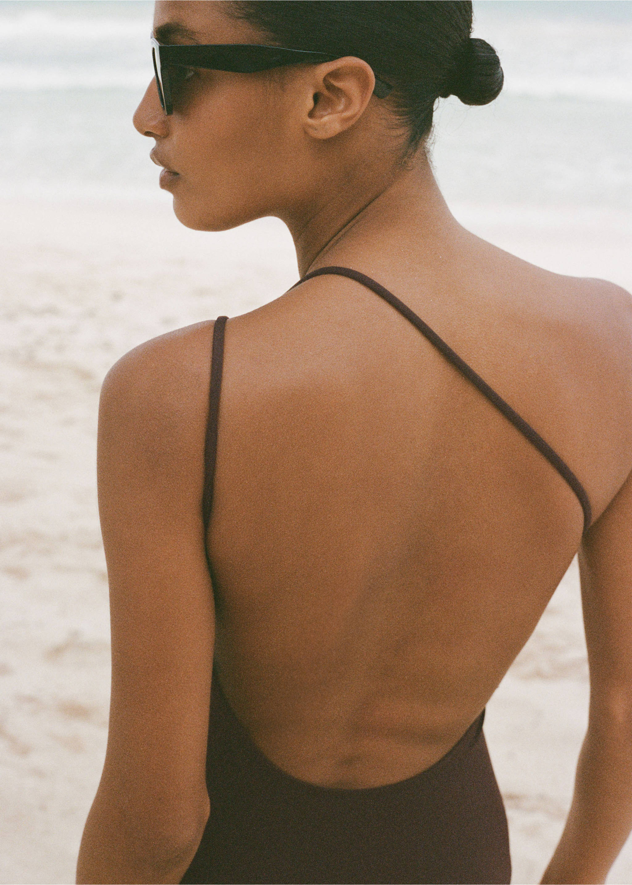 Dark brown one-piece swimsuit with asymmetrical thin straps and low back., Chocolate. Ref: 87024390-00.