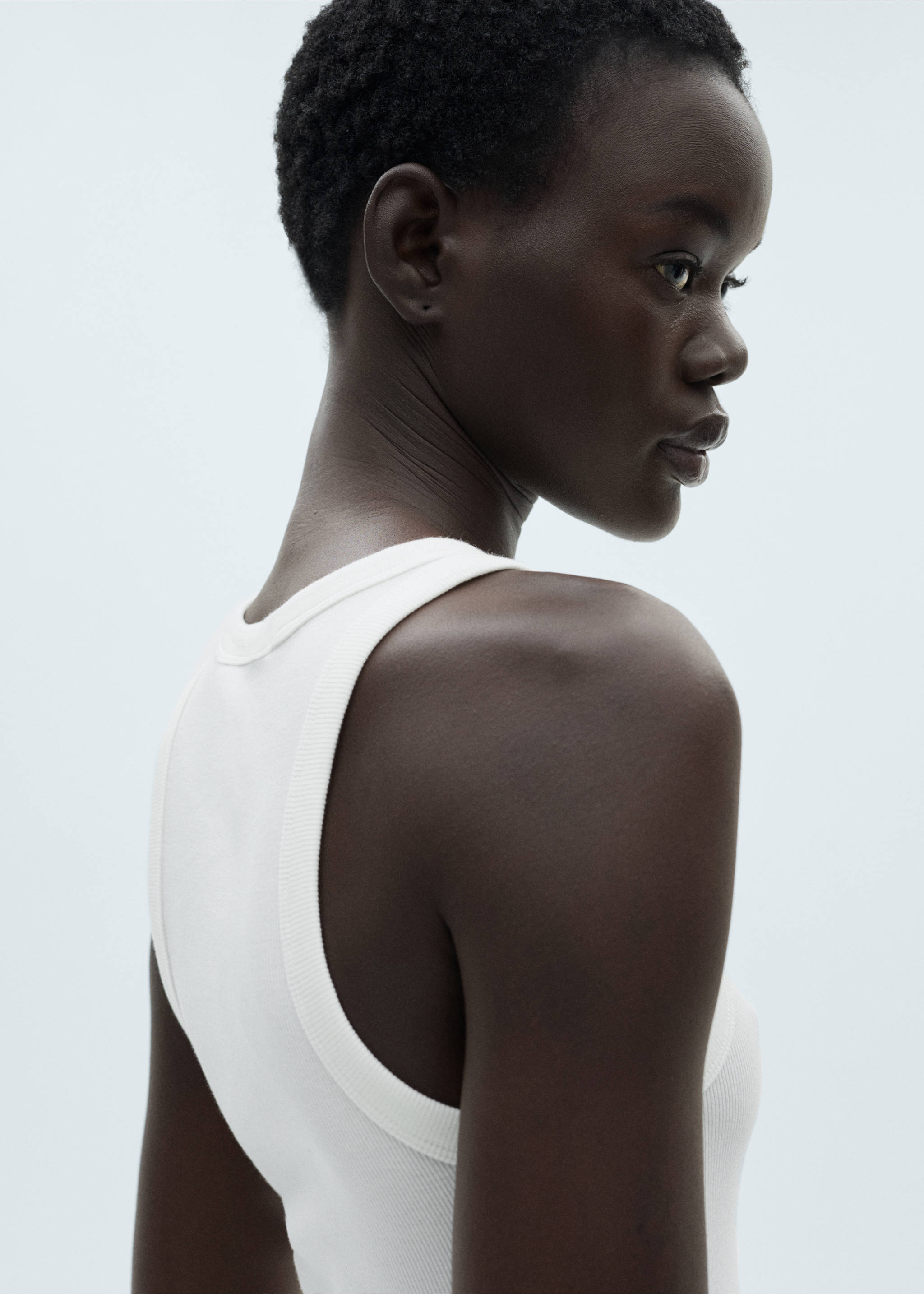 White ribbed top in a close-up view showing the shoulder and neckline., White. Ref: 87060433-00.