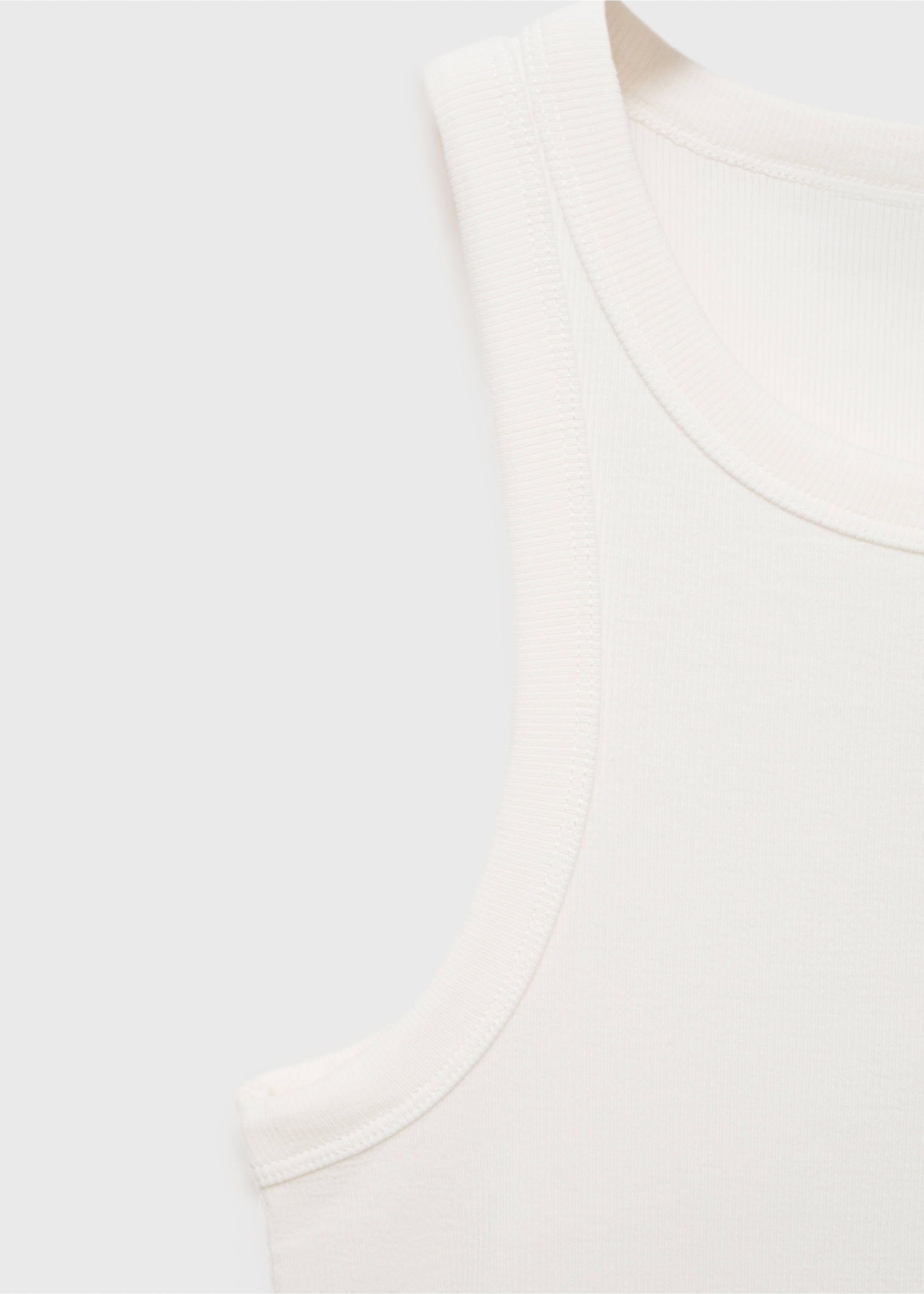 Close-up of the ribbed fabric detail and scoop neckline of an off-white top., White. Ref: 87060433-00.