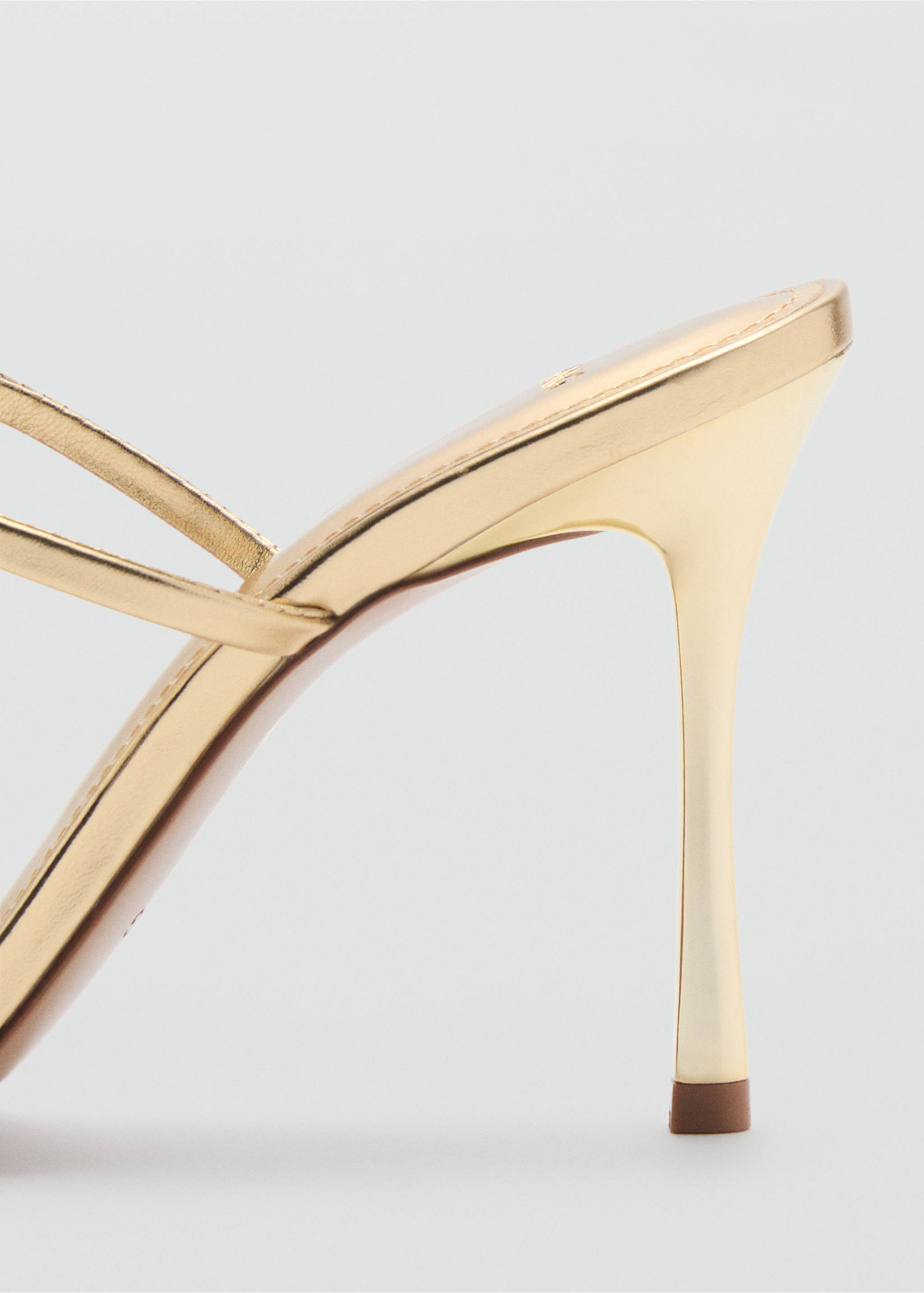 Close-up of a metallic gold heeled sandal showing the slim stiletto heel., Gold. Ref: 87064077-00.