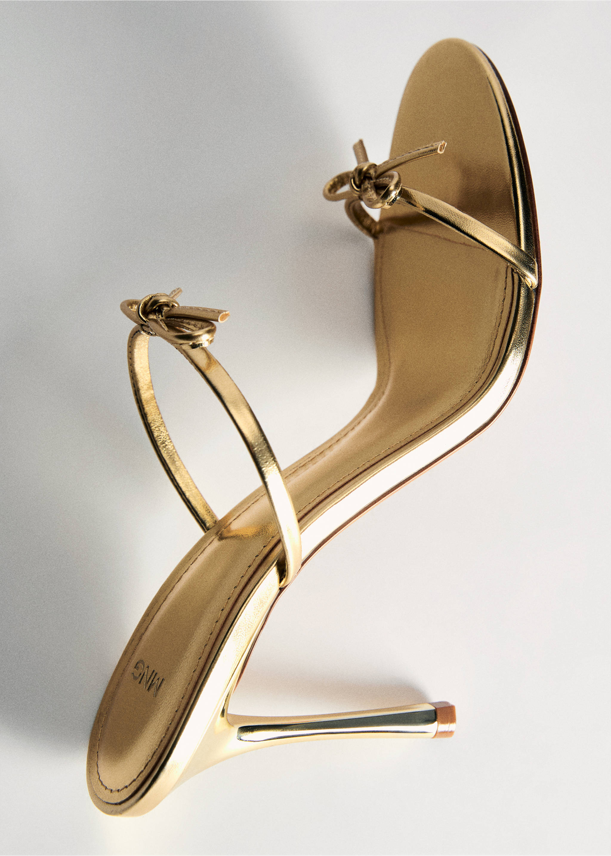 Metallic gold stiletto sandal with slim straps and bow details., Gold. Ref: 87064077-00.