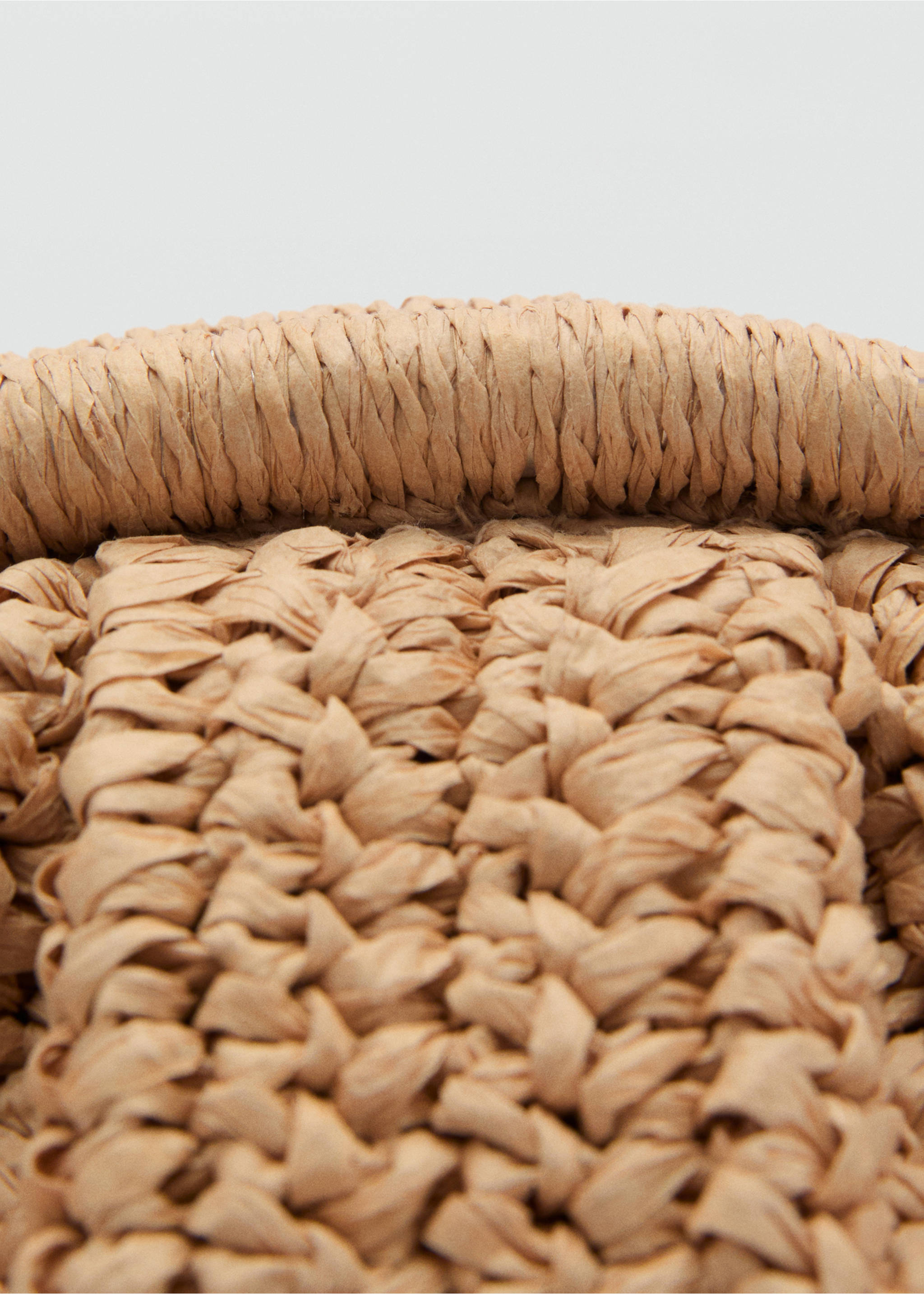 Close-up of a beige woven straw crossbody bag showing texture., Beige. Ref: 87065921-00.