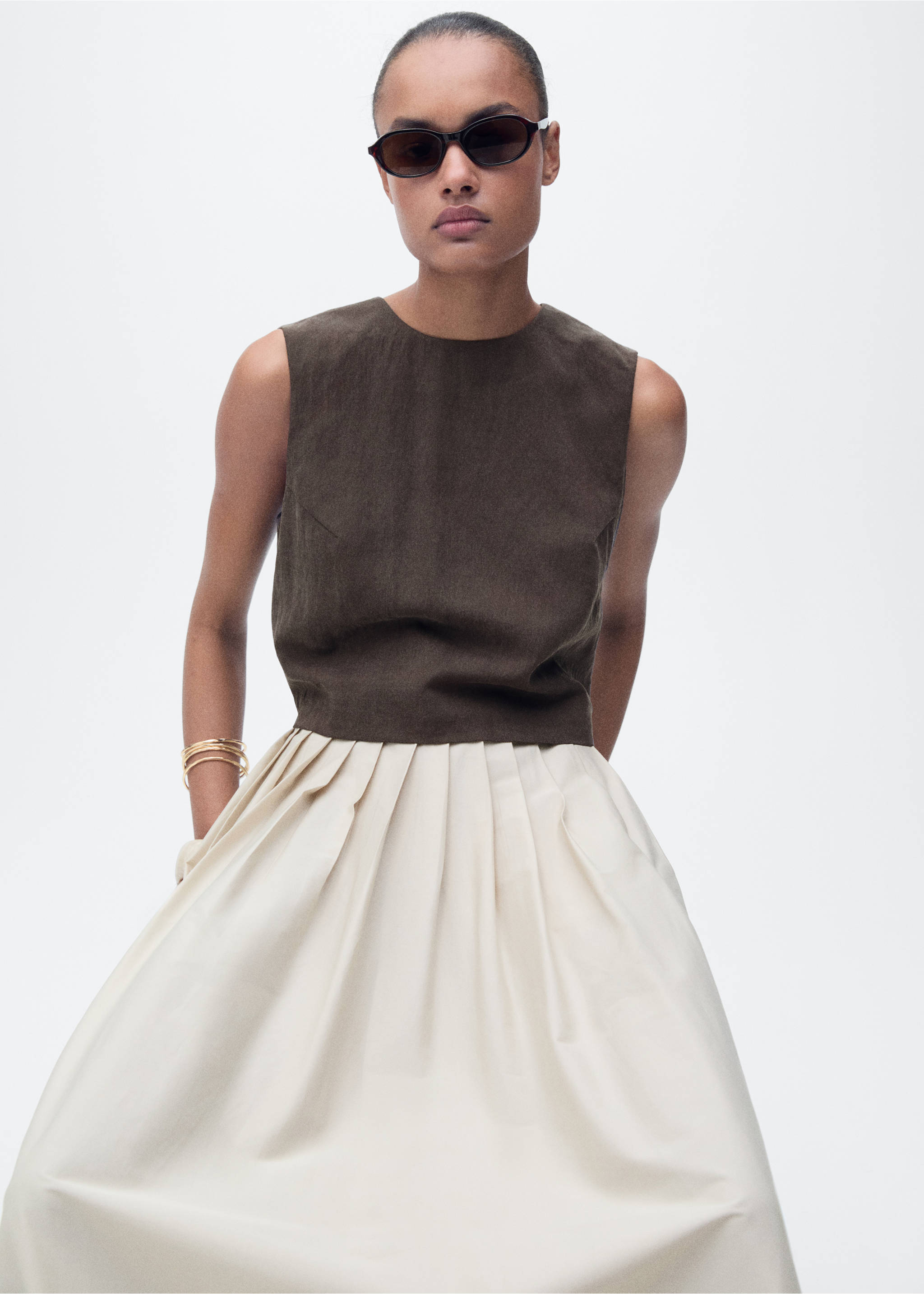 Dark brown sleeveless cropped top with a round neckline, paired with a cream-coloured pleated skirt., Brown. Ref: 87068263-00.