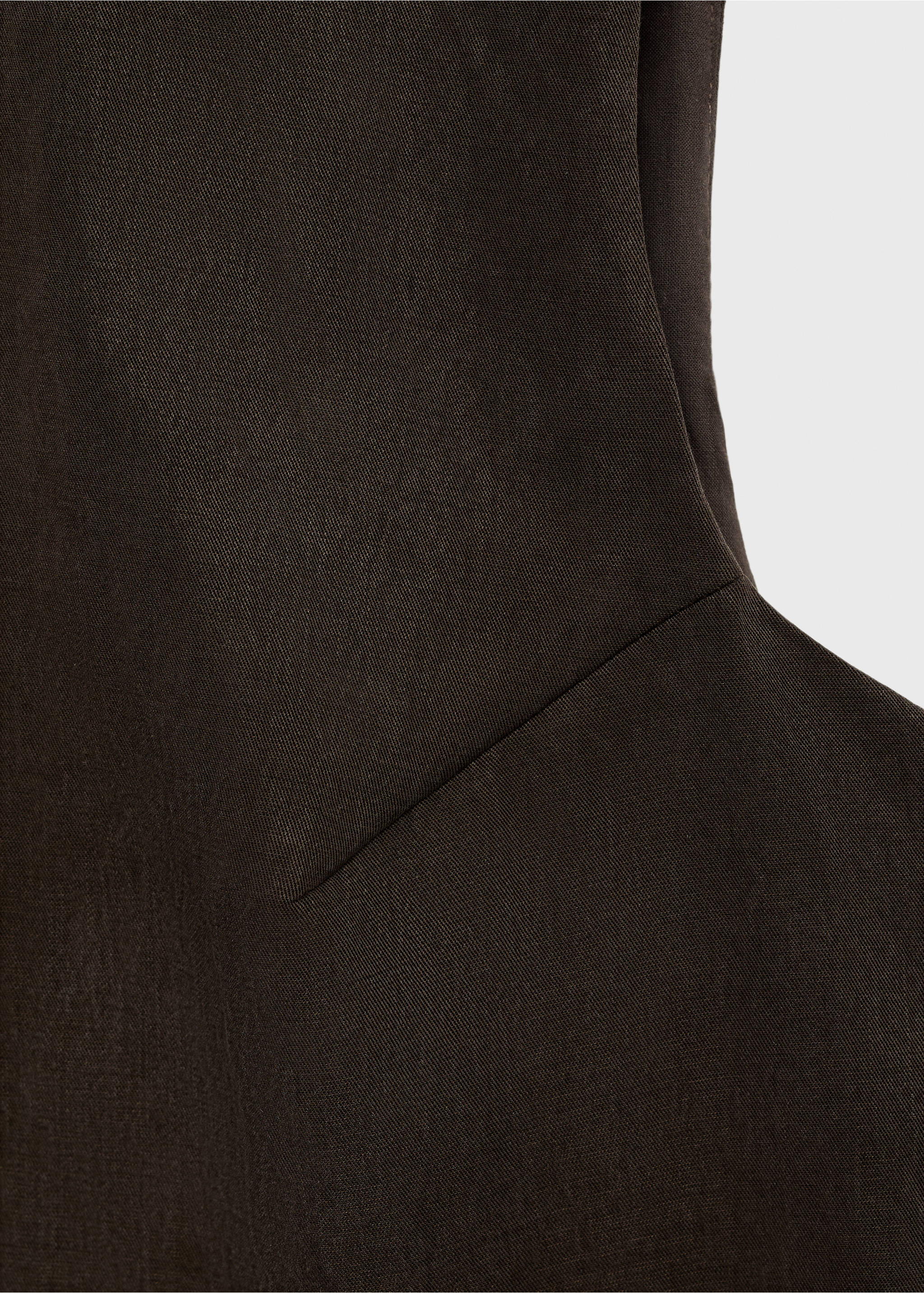 Close-up of a dark brown top showing its fabric texture and panel seam., Brown. Ref: 87068263-00.
