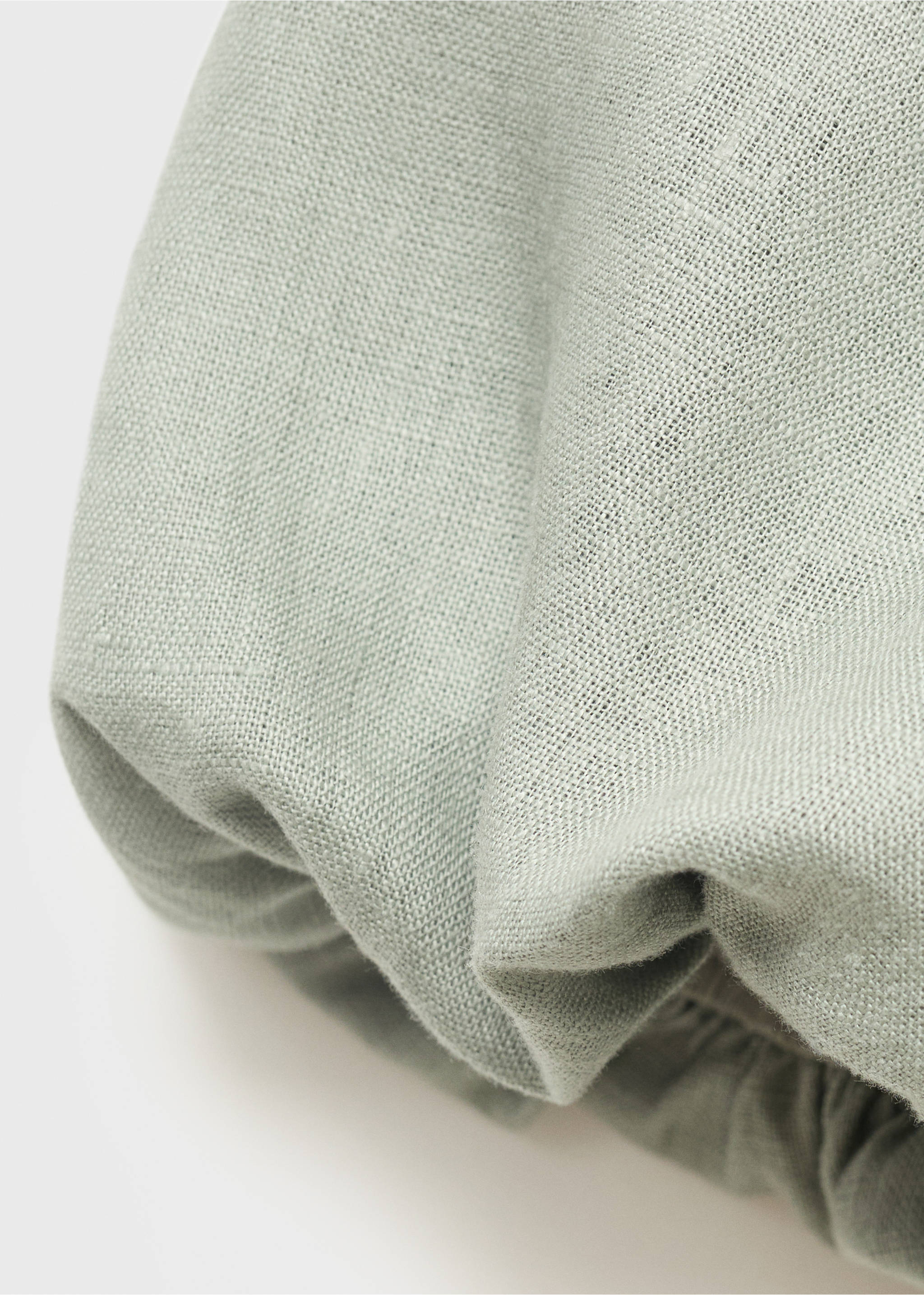 Close-up of pale sage green dress fabric showing texture and gathers., Green. Ref: 87076712-00.