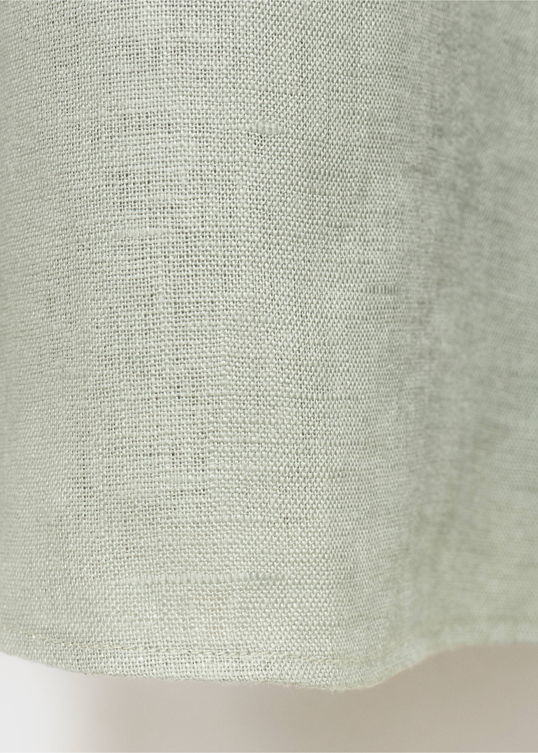 Close-up of the textured, woven fabric of a light green dress., Green. Ref: 87076712-00.